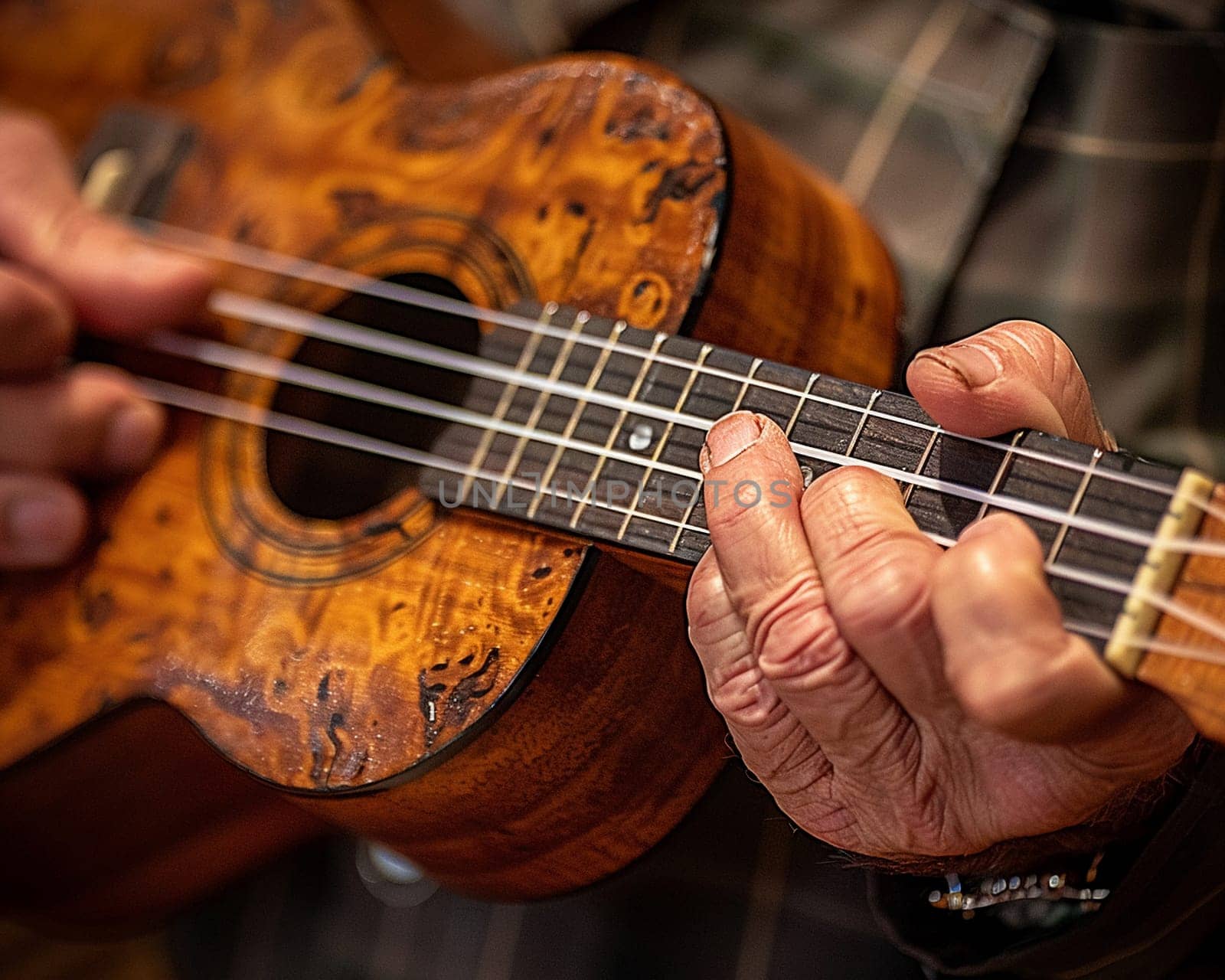 Close-up of a hand strumming a ukulele showcasing music by Benzoix