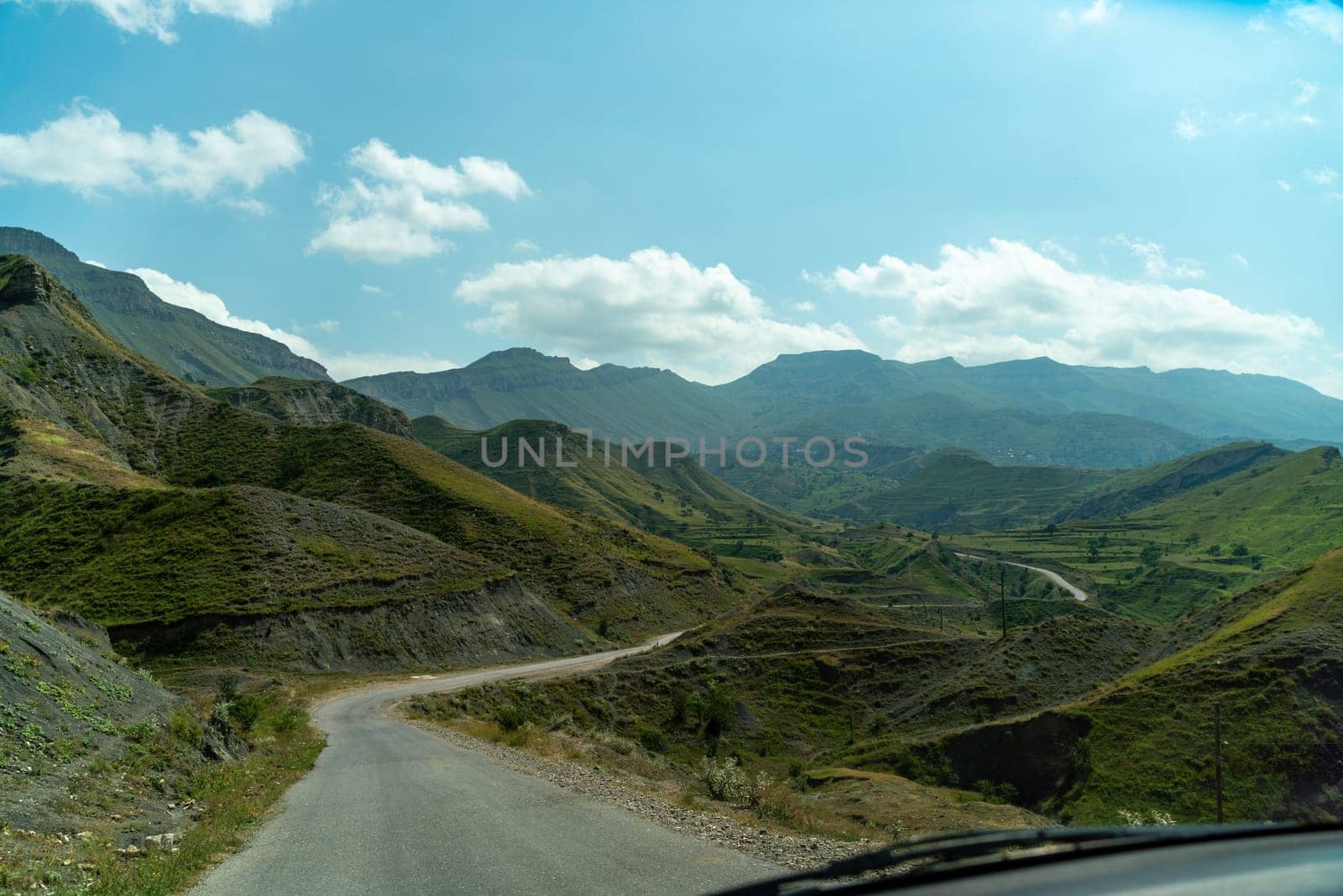 View from the car of an asphalt road in the mountainous area of Dagestan by Matiunina