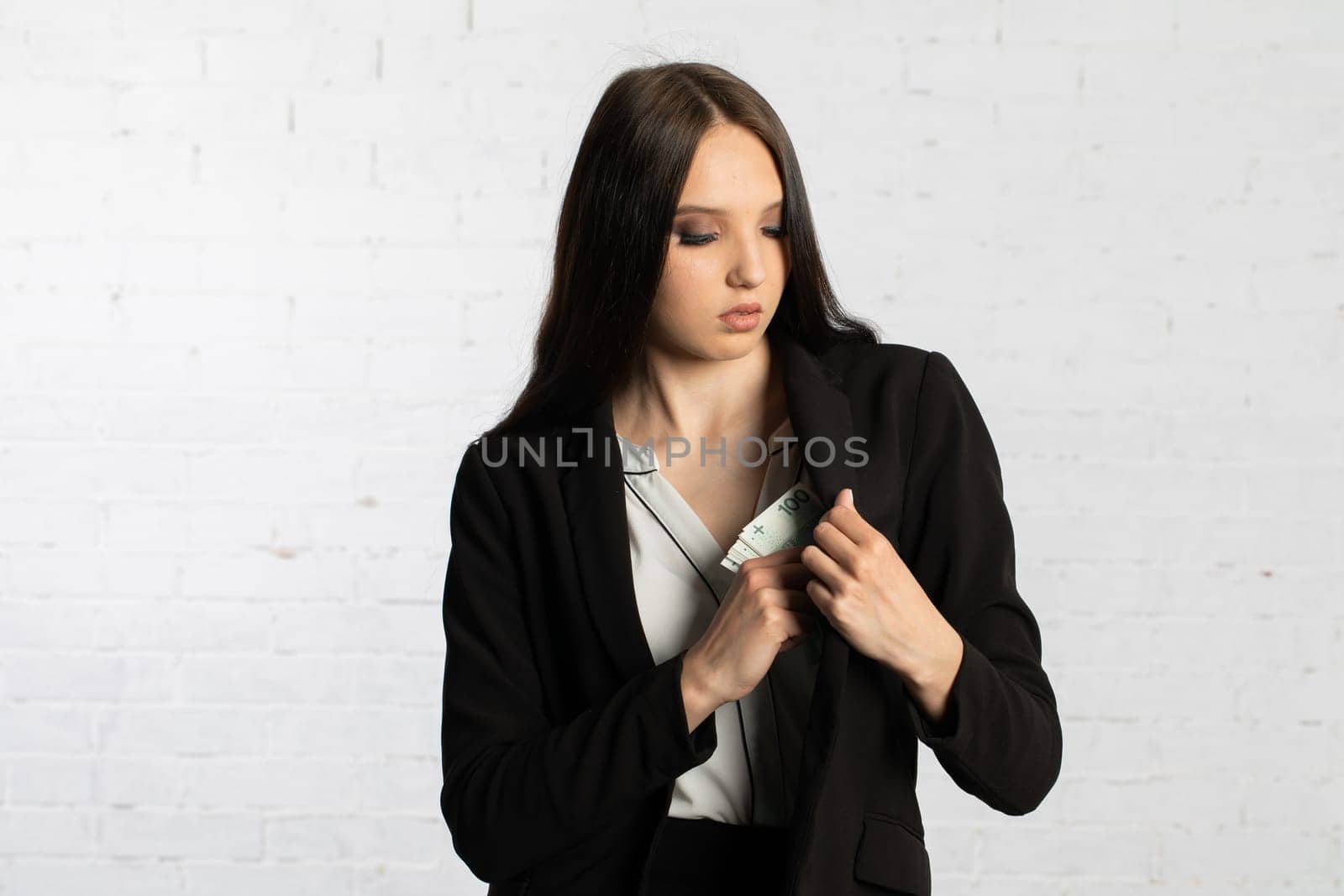 After a successful transaction, the woman puts a thick bundle of paper banknotes into her pocket.