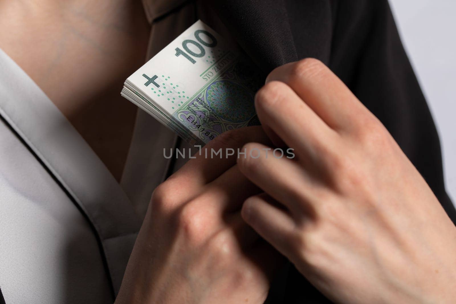 After a successful transaction, the woman puts a thick bundle of paper banknotes into her pocket.