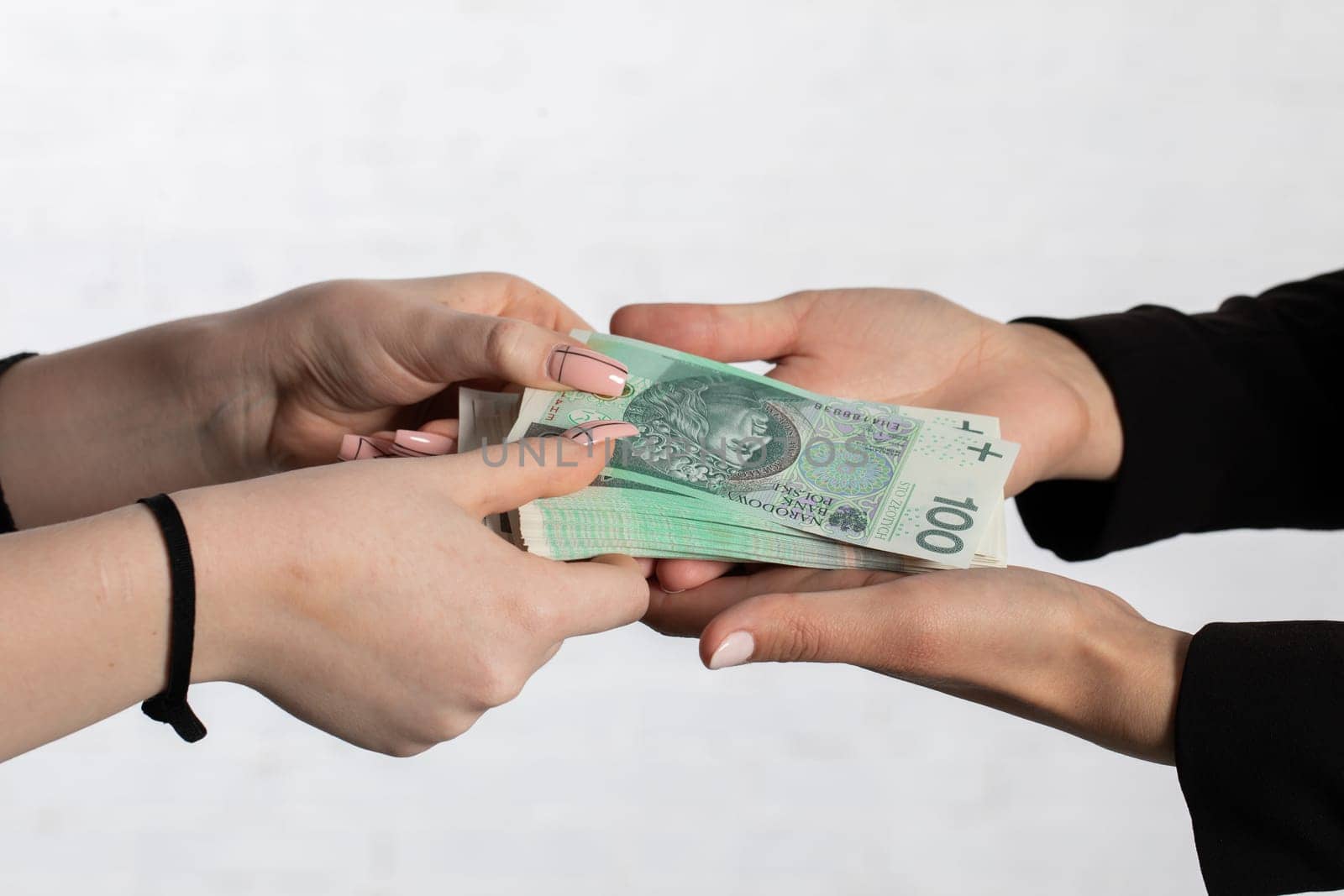 On the zoom you can see female hands full of banknotes as they exchange cash.