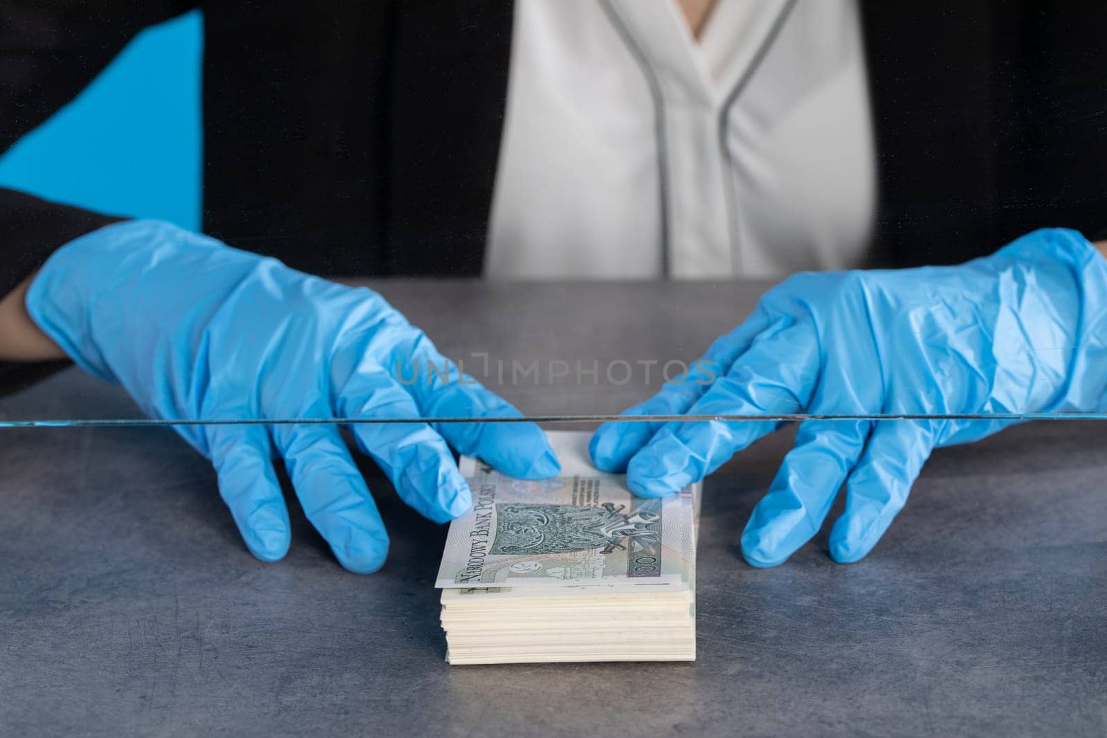 A bank employee in her position prepared for issuing a bundle of banknotes.