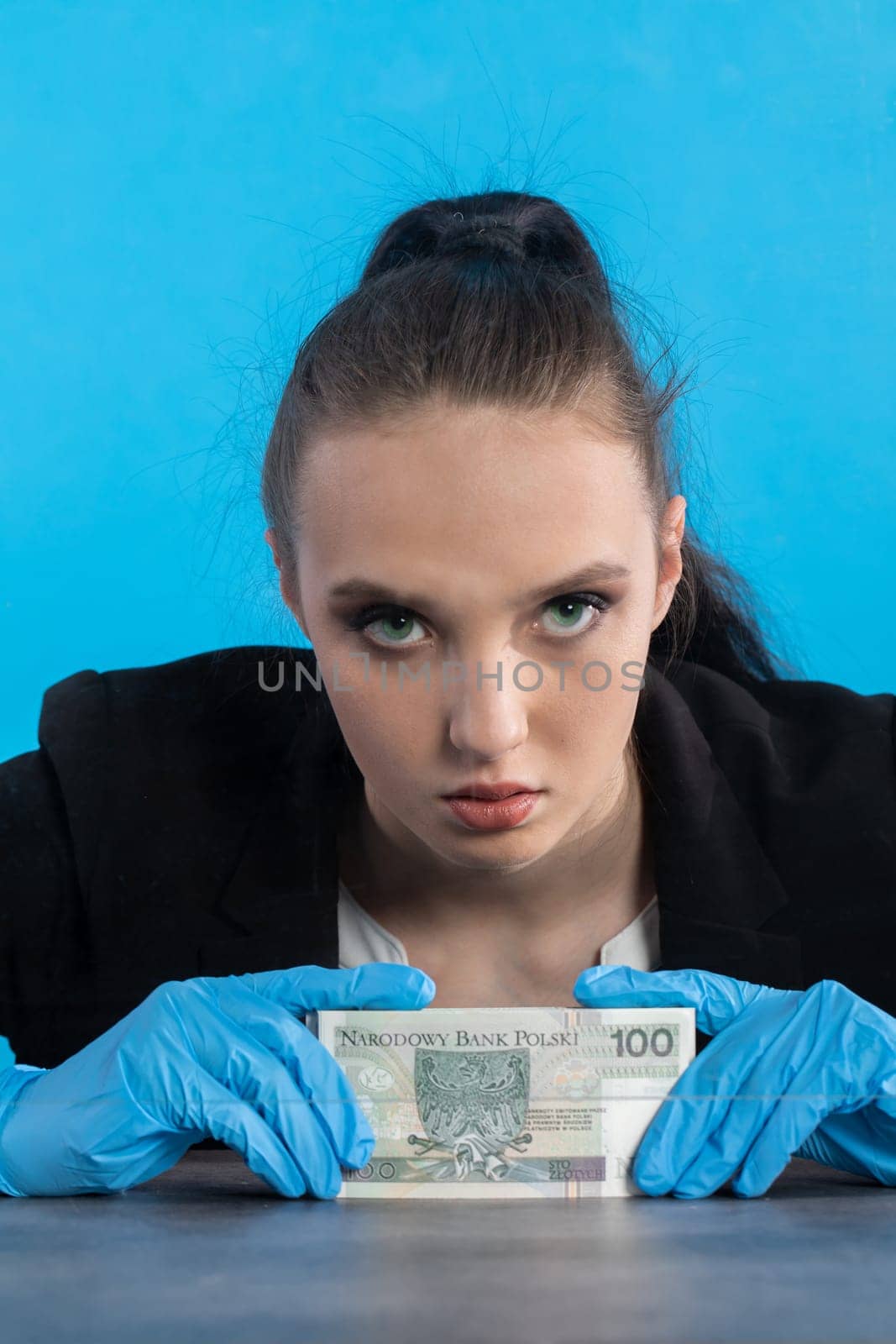 A bank employee in her position prepared for issuing a bundle of banknotes.