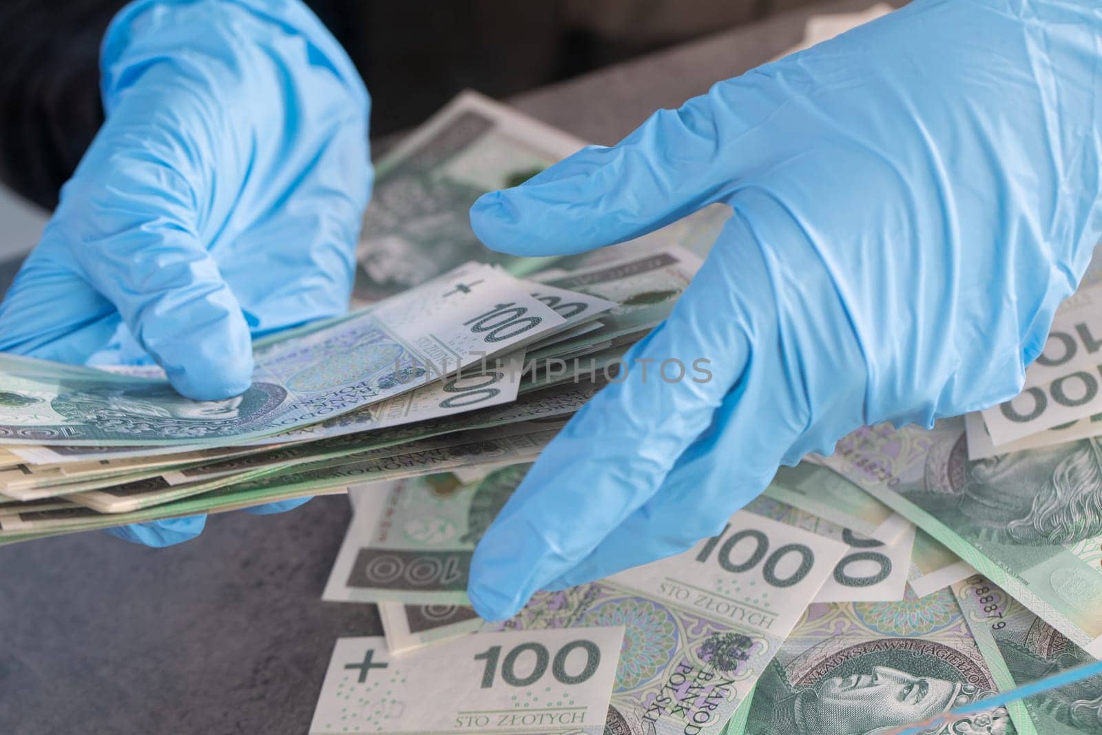 During an ongoing epidemic of infectious disease, the cashier gives cash in protective gloves.