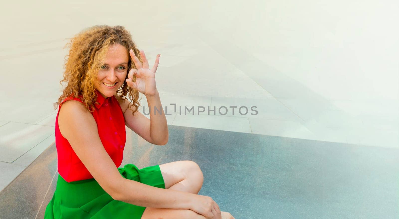 Beautiful fashionable businesswoman smiling making and showing ok hand sign fingers by kajasja