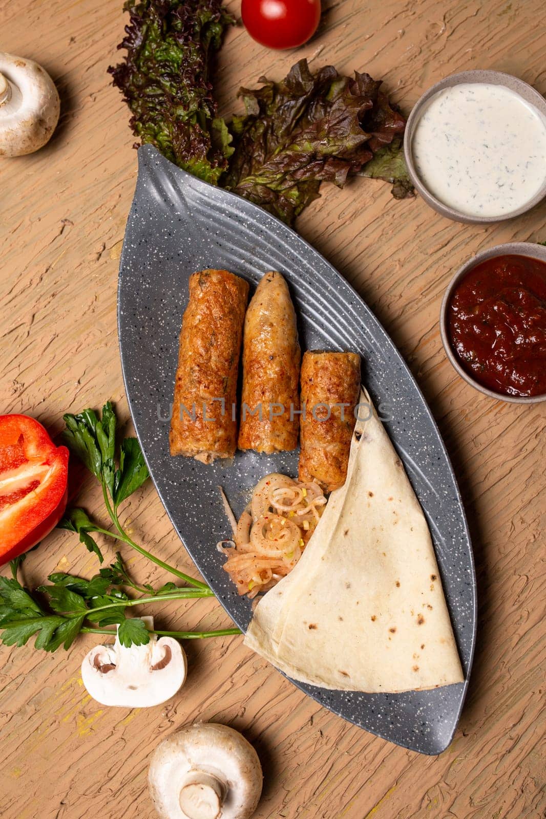 Top view Chicken Kebab Skewers with Grilled Vegetables and Fresh Herbs on Wooden Table by Pukhovskiy