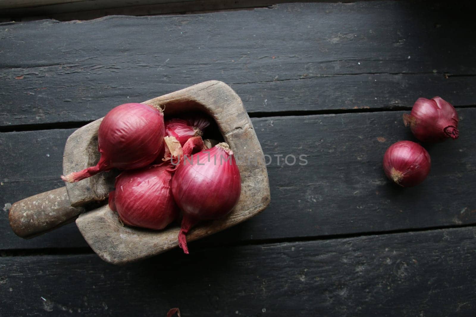 Healthy food. Red onion in a box on a old vintage table