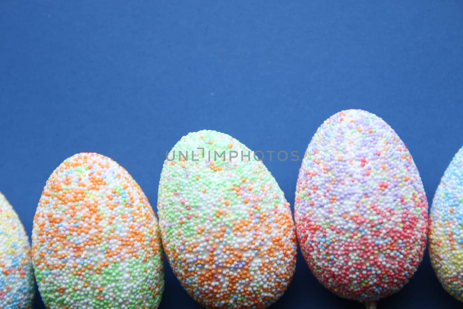 Easter holiday background with Easter eggs. Colorful Easter Eggs on Blue Background