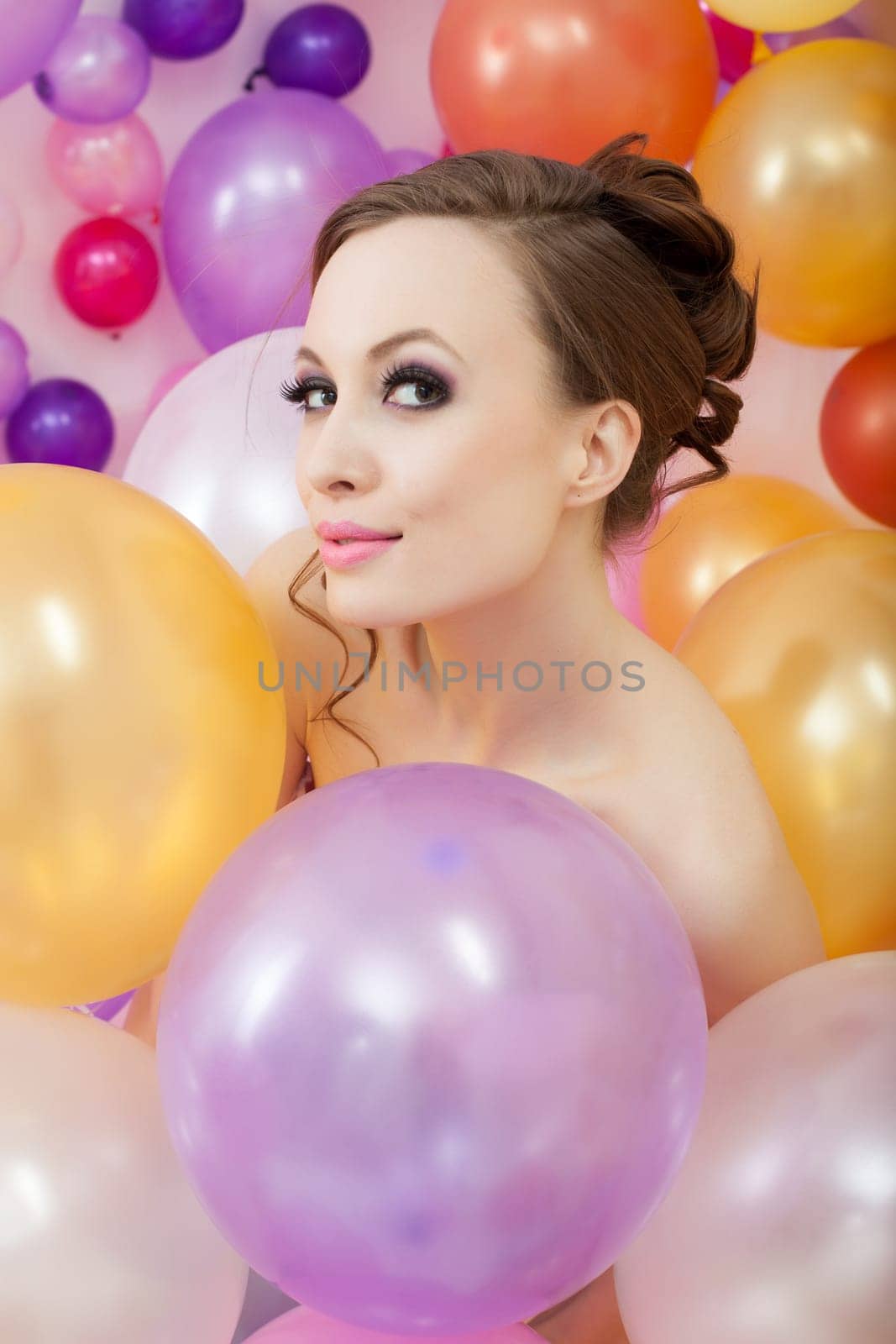 Portrait of playful brunette posing with balloons