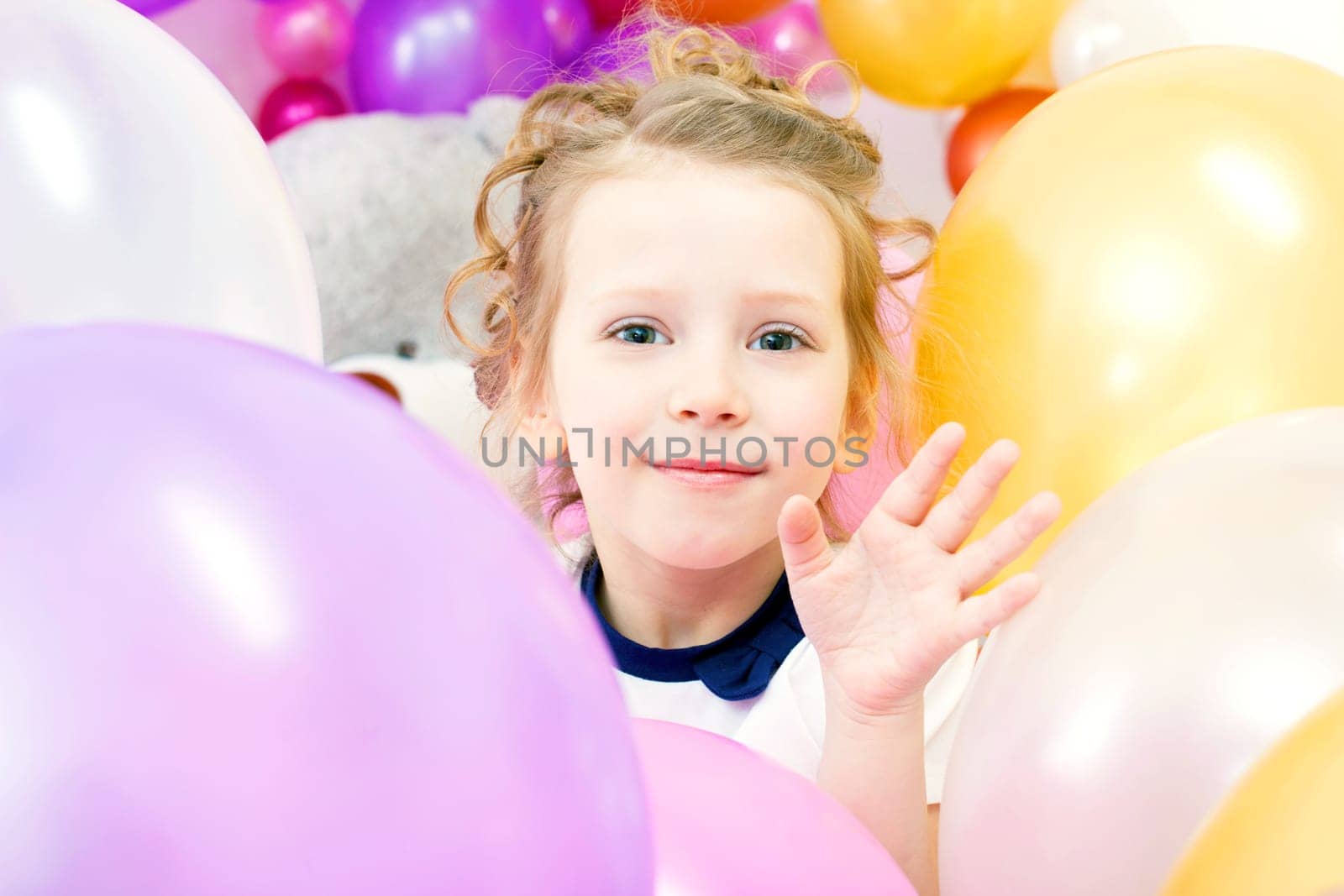 Cheerful girl posing with colorful balloons, close-up