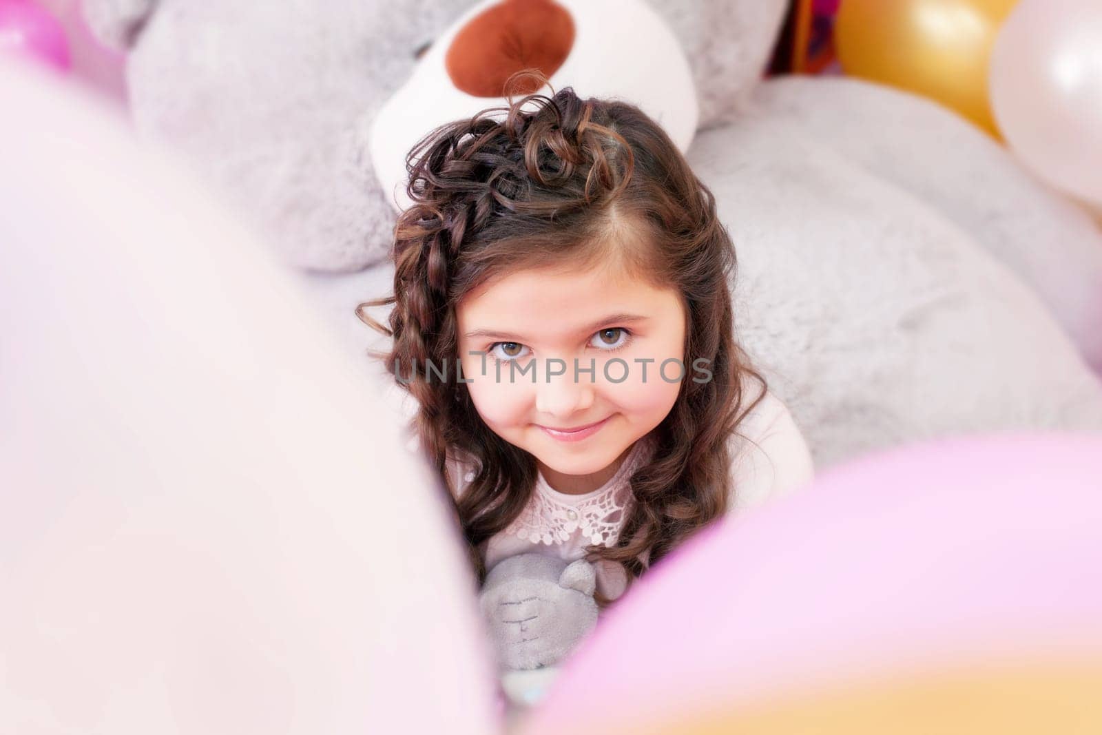 Portrait of lovely little brown-eyed girl posing at camera