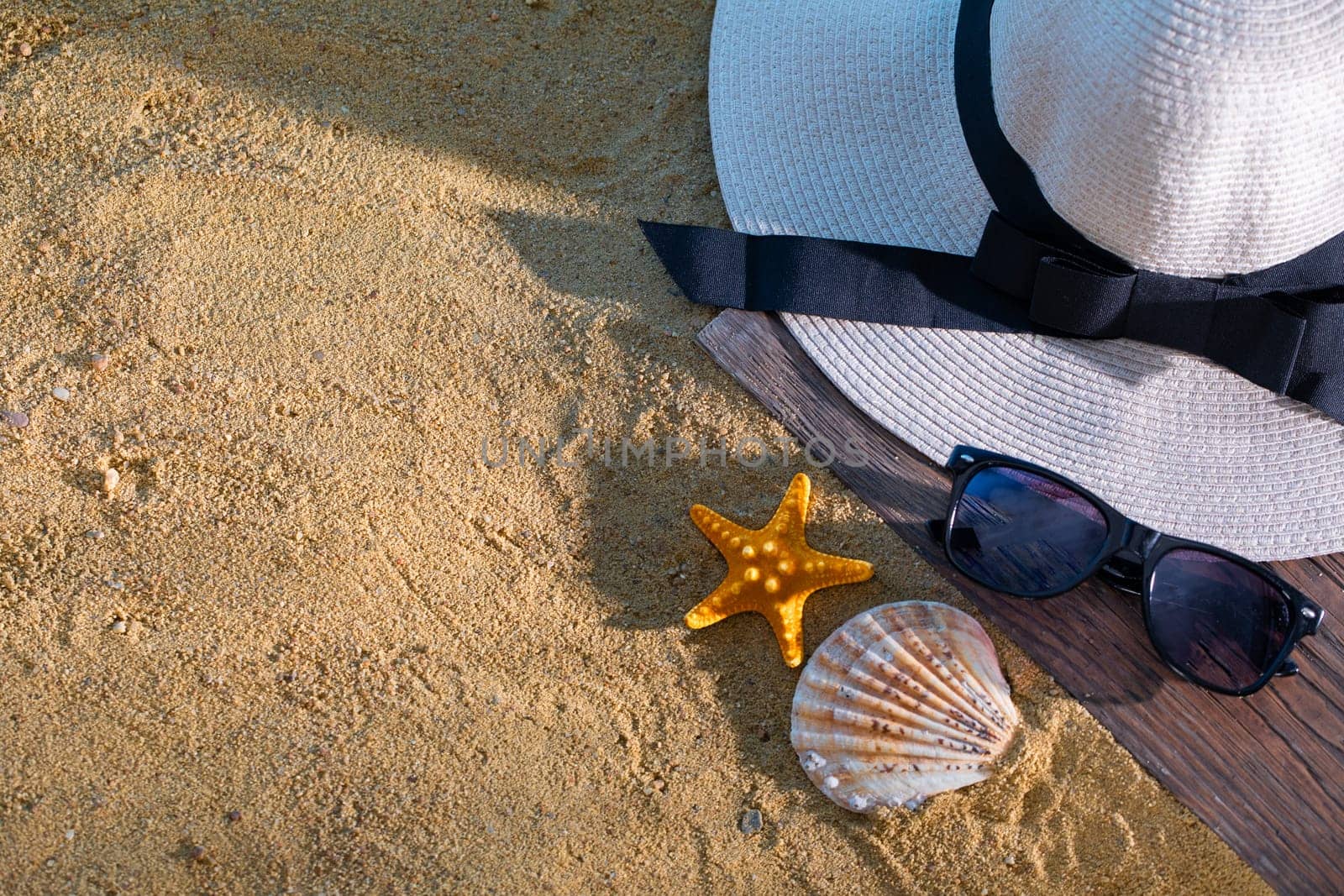 A decorative hat was laid on the sea beach and lies on a wet squeak.