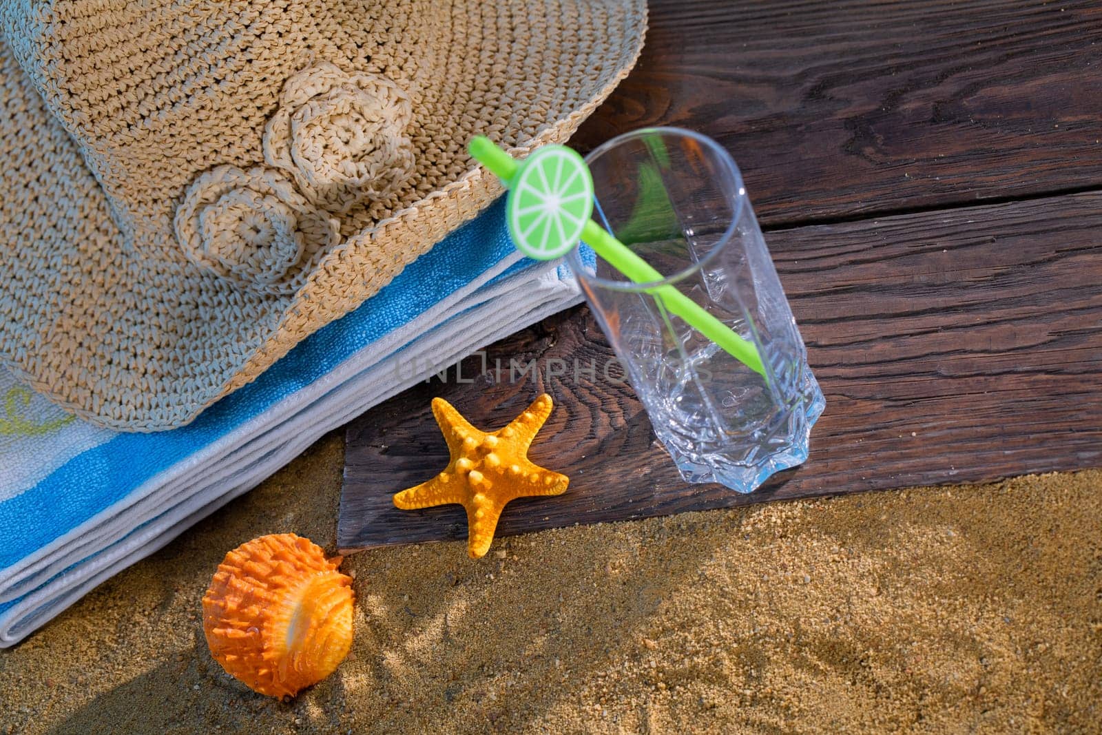 Summer hat for a holiday. An empty glass for a refreshing drink.