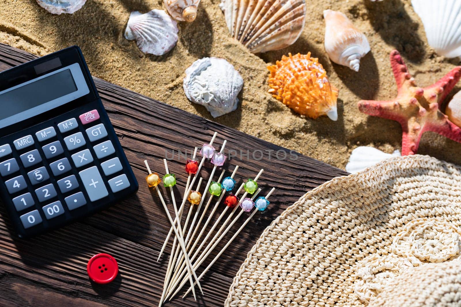 A thoughtful holiday trip with a calculator in hand. Sea beach full of felt-tip pen and shells.