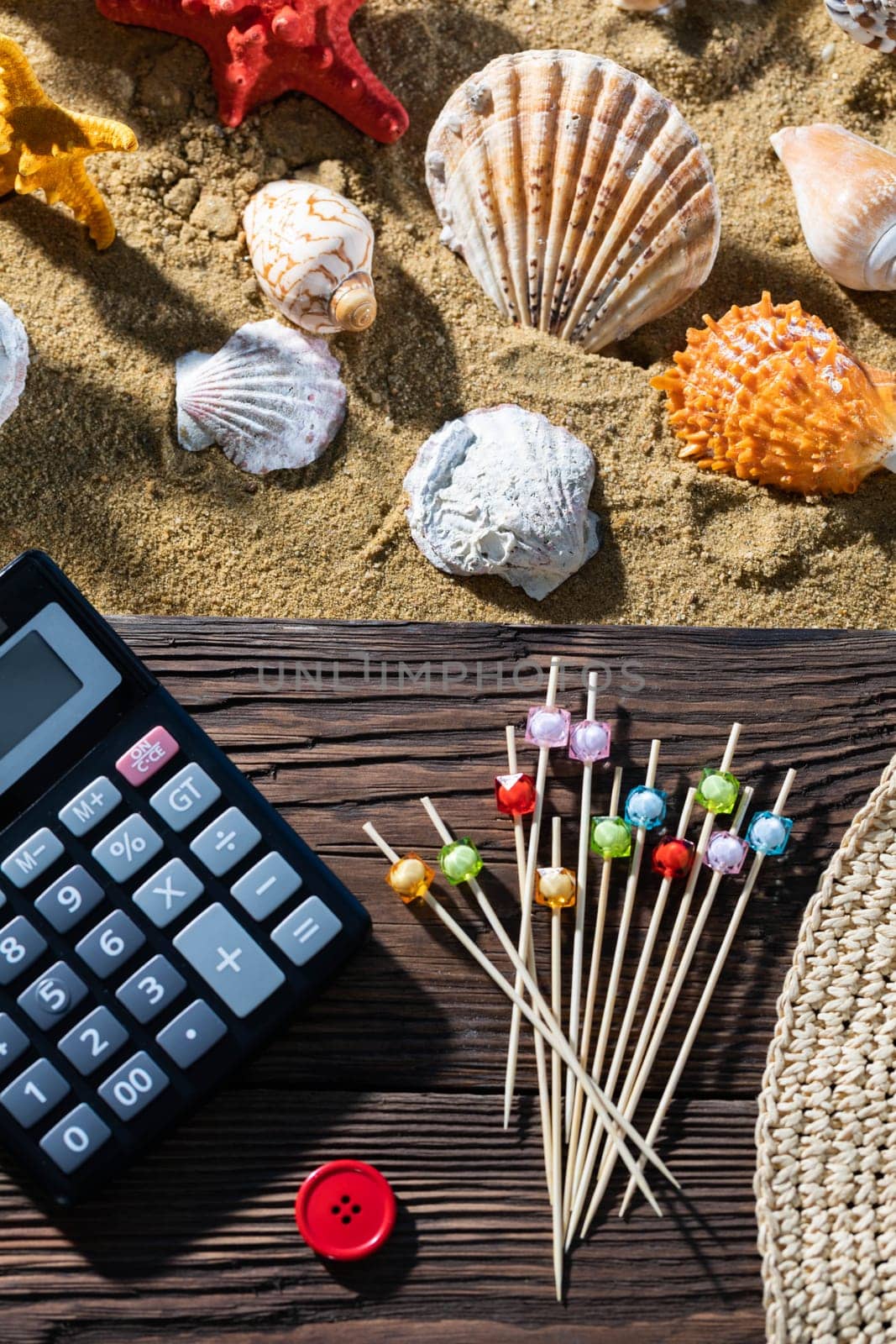 A thoughtful holiday trip with a calculator in hand. Sea beach full of felt-tip pen and shells.