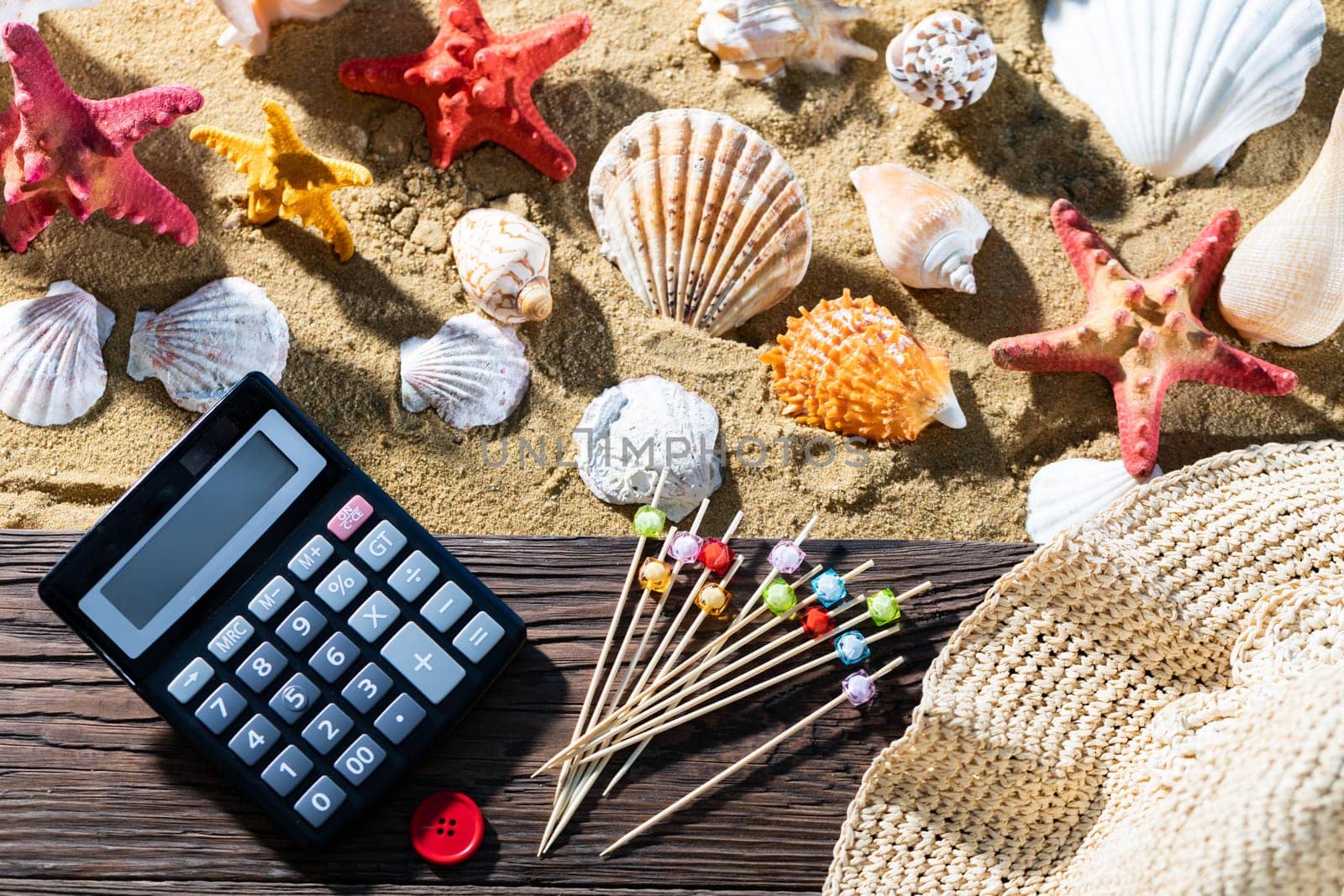 A thoughtful holiday trip with a calculator in hand. Sea beach full of felt-tip pen and shells.