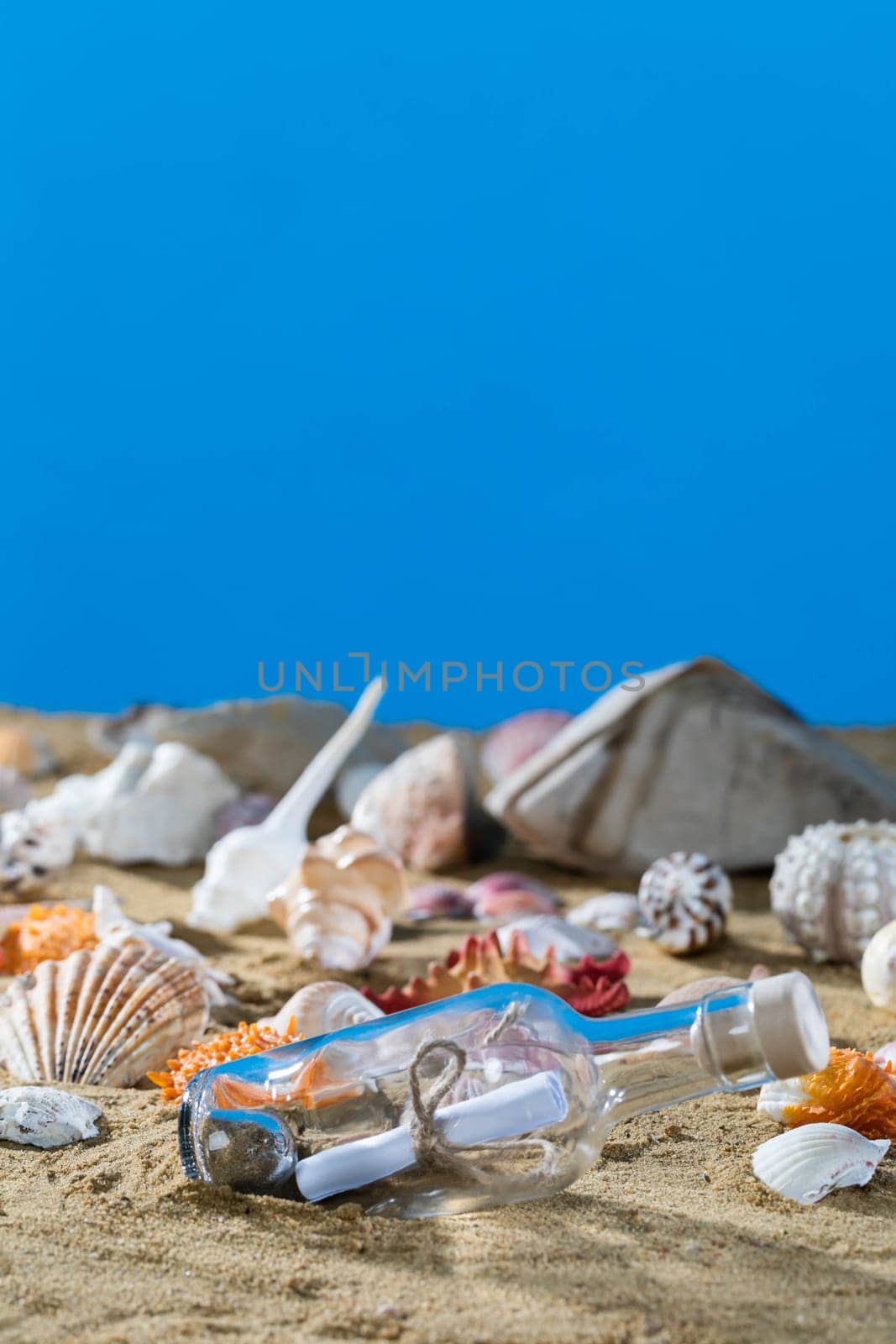 A glass bottle corked with a letter inside was on one of the sea wild beaches. Blue sky.