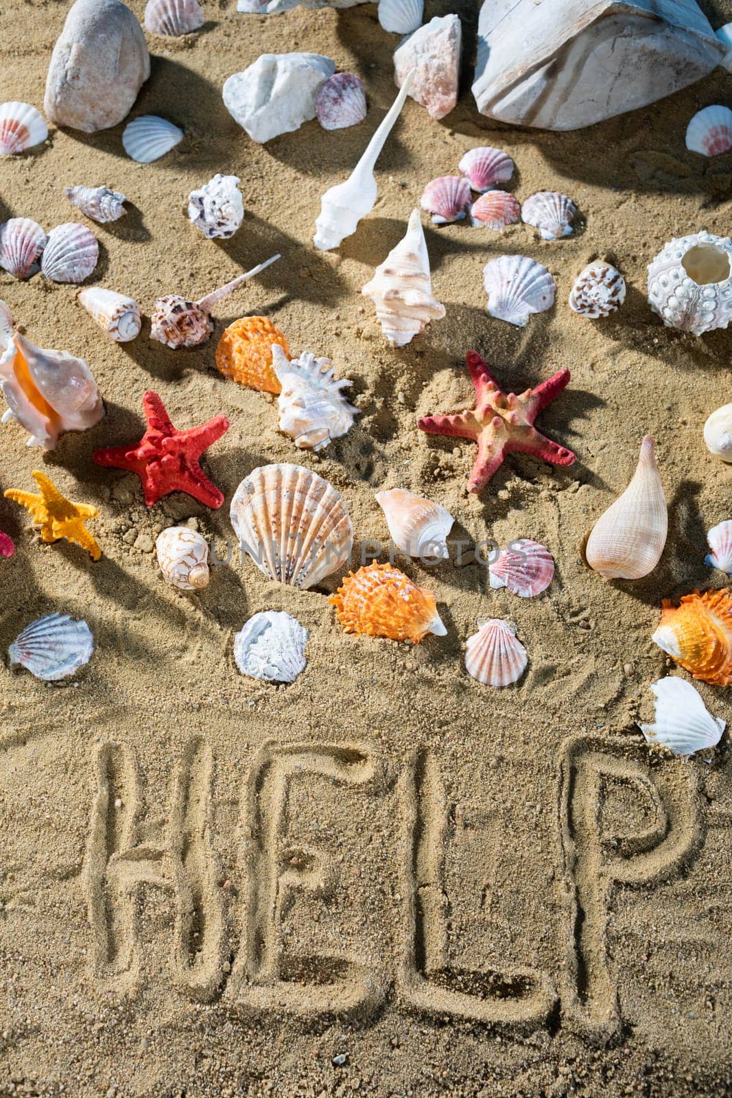 On the sand, the tourist wrote - help. Relaxing climate of a sea sandy and sunny beach.