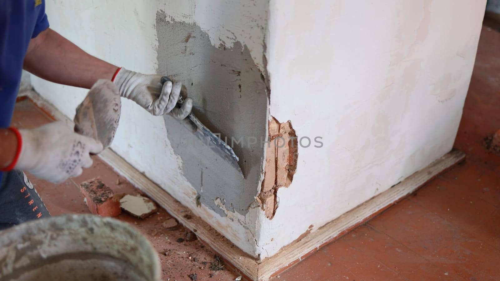 The stove painter is plastering the wall of the stove. by DovidPro