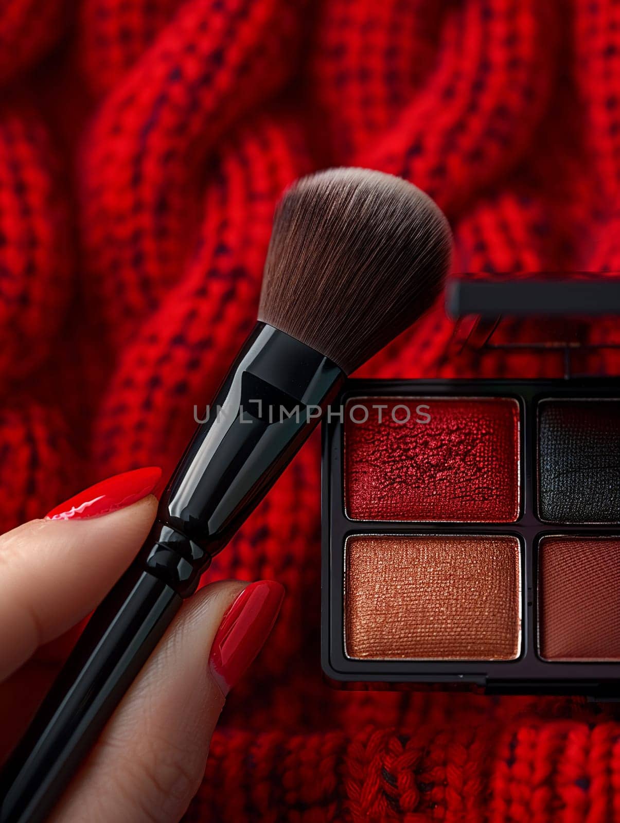 Fingers gently holding a makeup brush against a palette, symbolizing beauty routine.