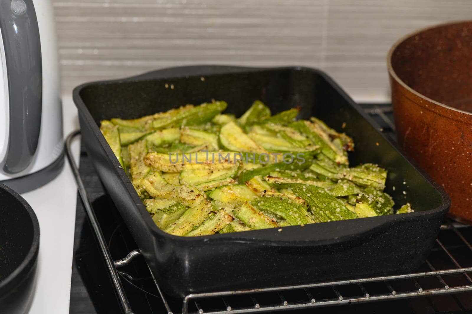 baked zucchini cut into sticks with sesame seeds cooked in the oven 5