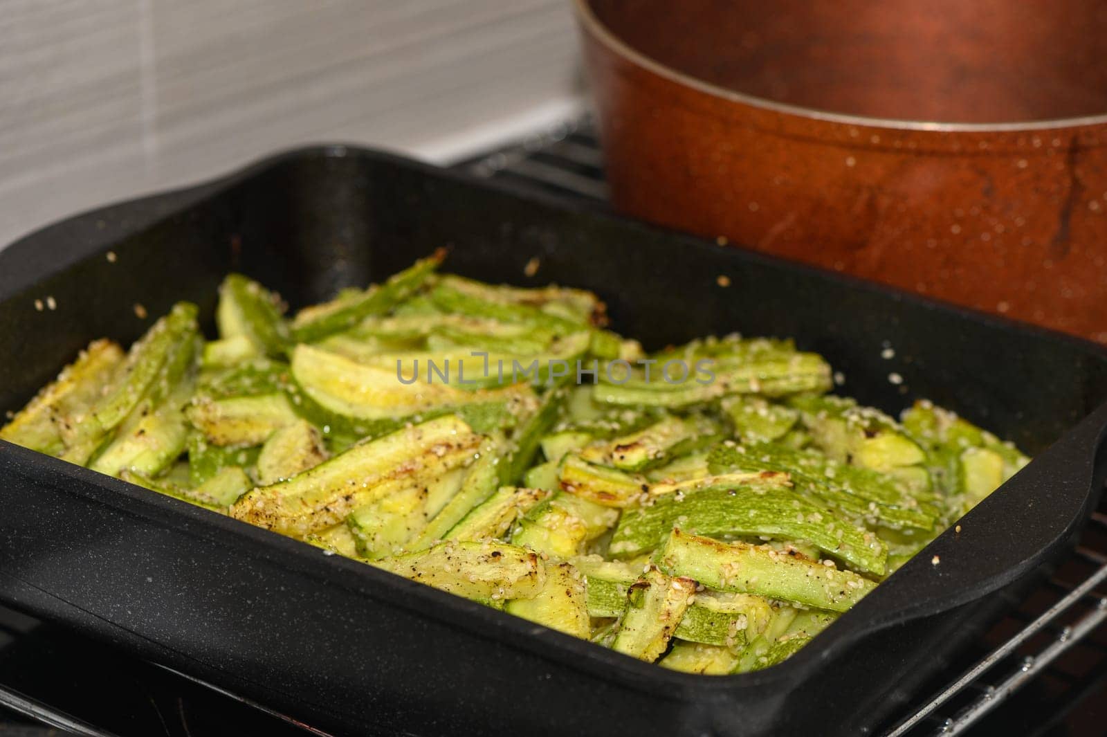 baked zucchini cut into sticks with sesame seeds cooked in the oven 4