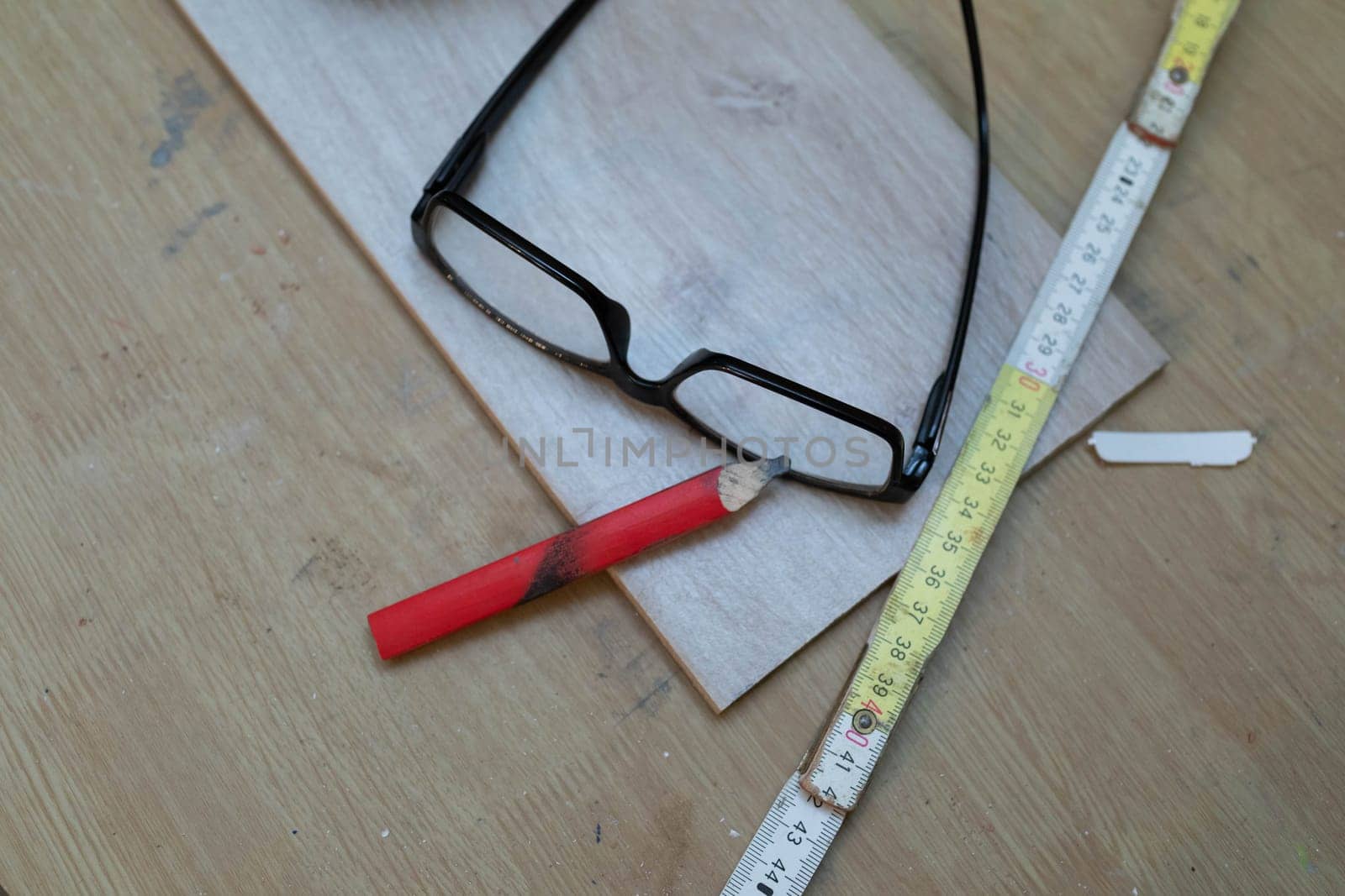 A table with the necessary tools such as a measuring cup, pencil and glasses.