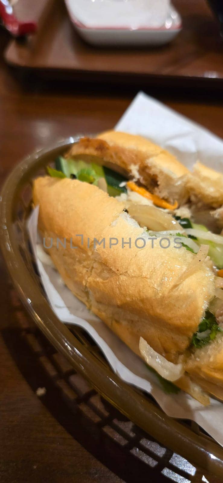 Sandwich Banh mi, vietnamese baguette with grilled chicken and mixed salad, vietnamese sandwich in local asian restaurant
