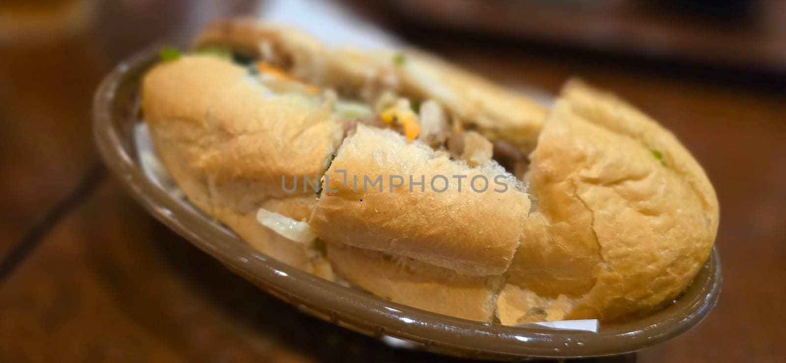 Sandwich Banh mi, vietnamese baguette with grilled chicken and mixed salad, vietnamese sandwich in local asian restaurant