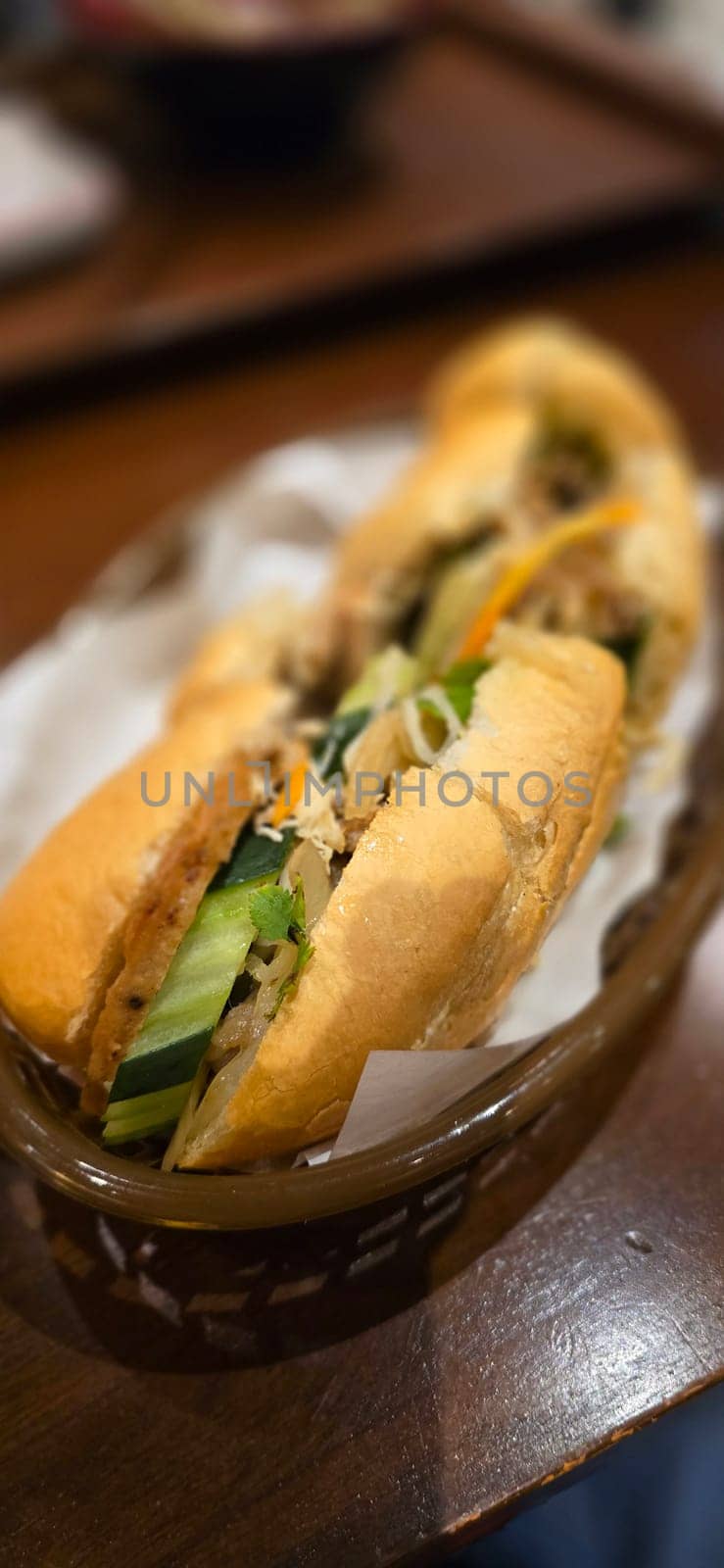 Sandwich Banh mi, vietnamese baguette with grilled chicken and mixed salad, vietnamese sandwich in local asian restaurant