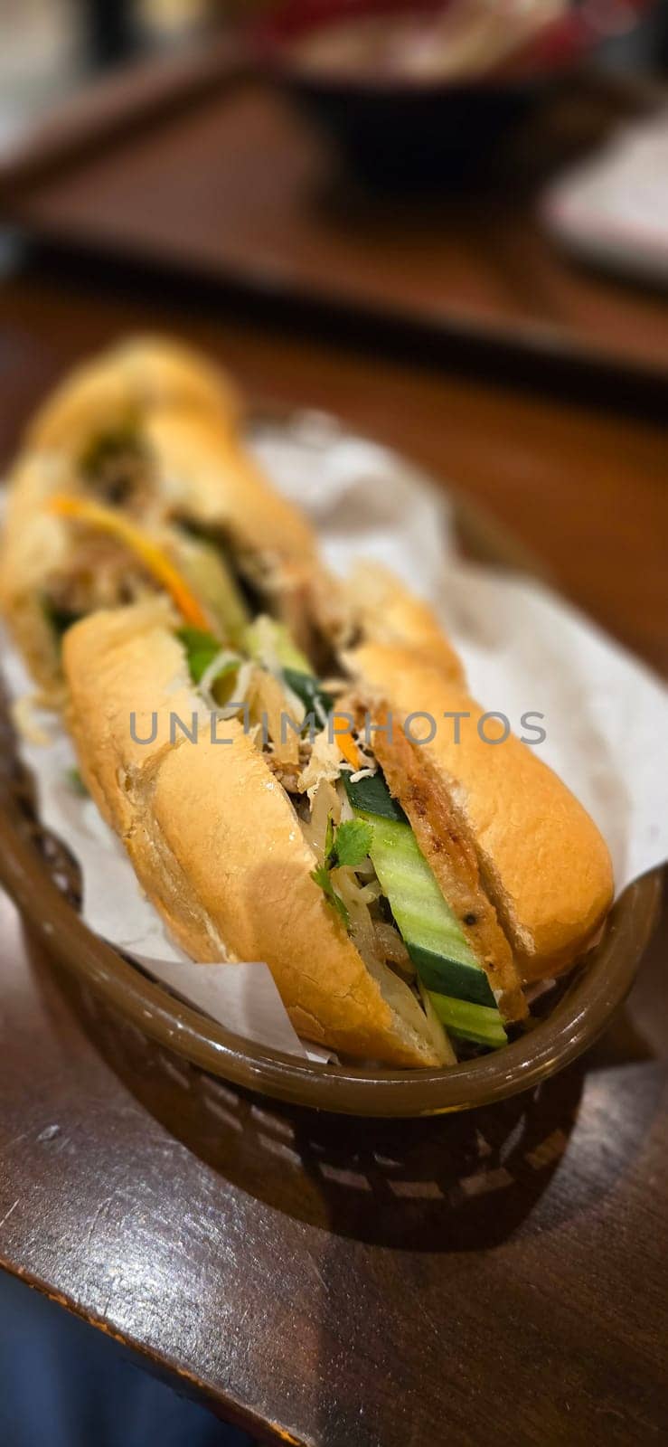 Sandwich Banh mi, vietnamese baguette with grilled chicken and mixed salad, vietnamese sandwich in local asian restaurant