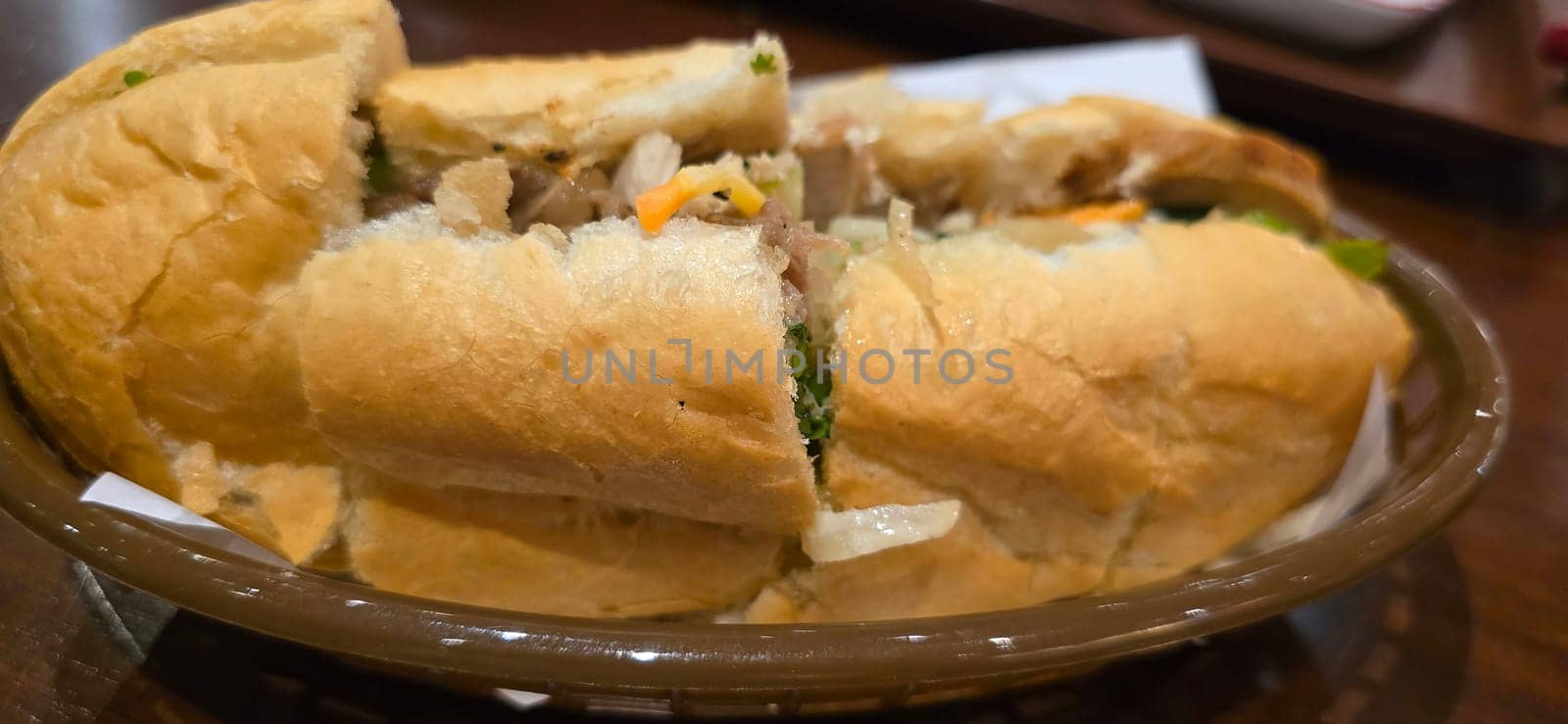 Sandwich Banh mi, vietnamese baguette with grilled chicken and mixed salad, vietnamese sandwich in local asian restaurant