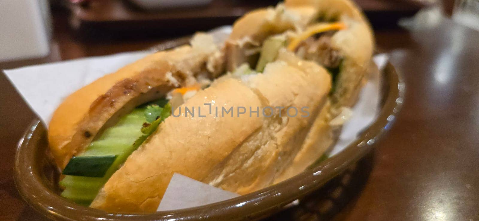 Sandwich Banh mi, vietnamese baguette with grilled chicken and mixed salad, vietnamese sandwich in local asian restaurant