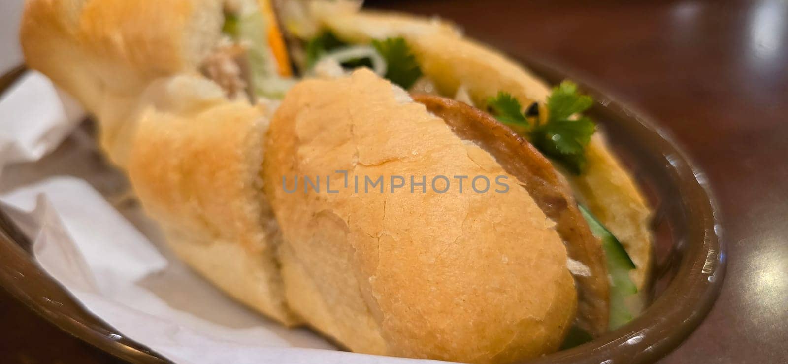 Sandwich Banh mi, vietnamese baguette with grilled chicken and mixed salad, vietnamese sandwich in local asian restaurant