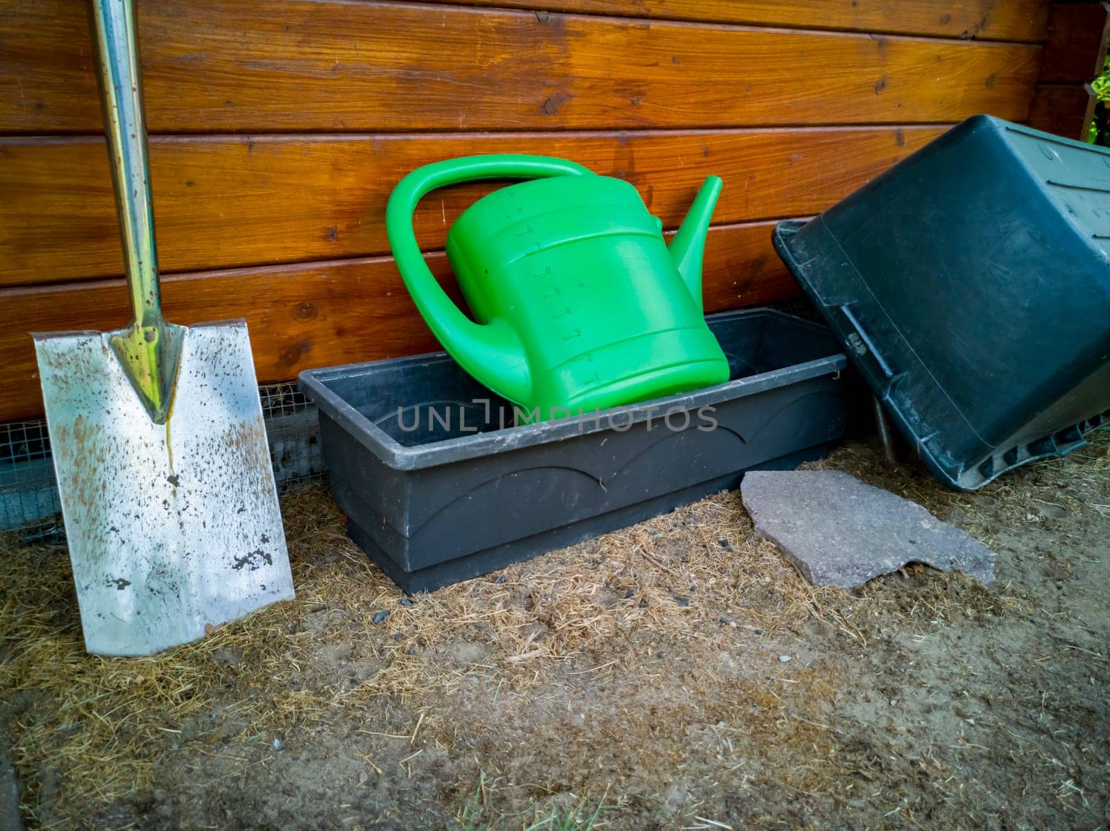 Gardening tools, watering can, shovel and pots.