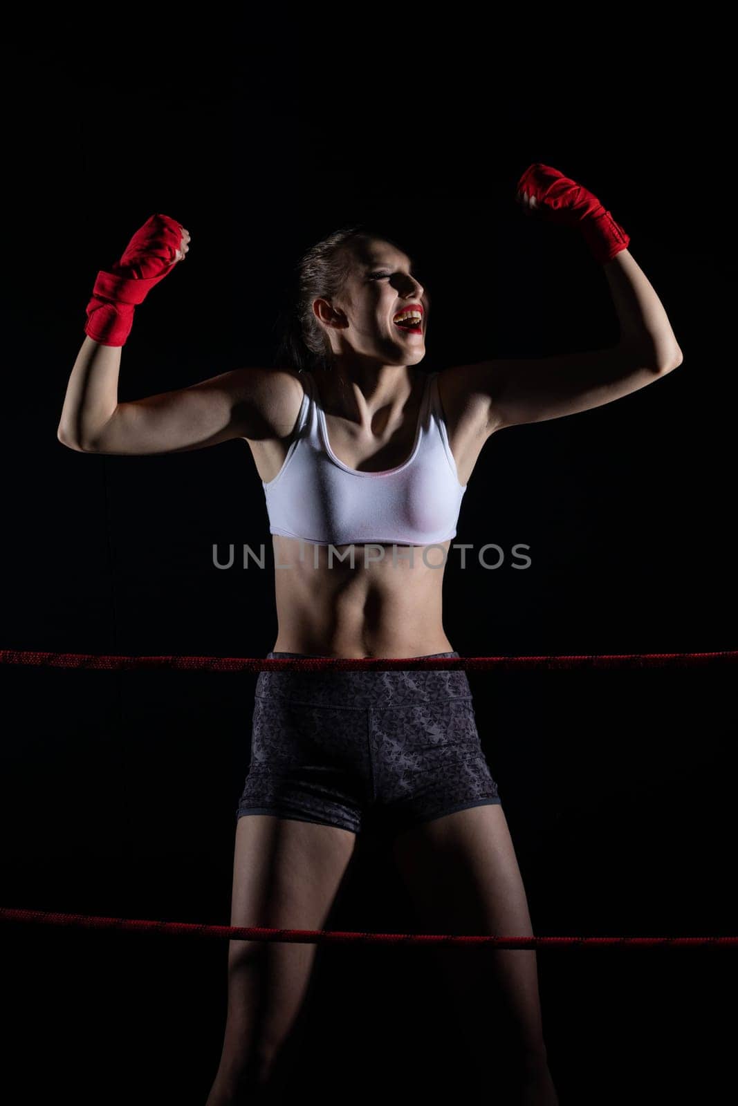 She is an athlete after winning the fight in sports competitions. A fight won by a professional sports player. Strong woman.