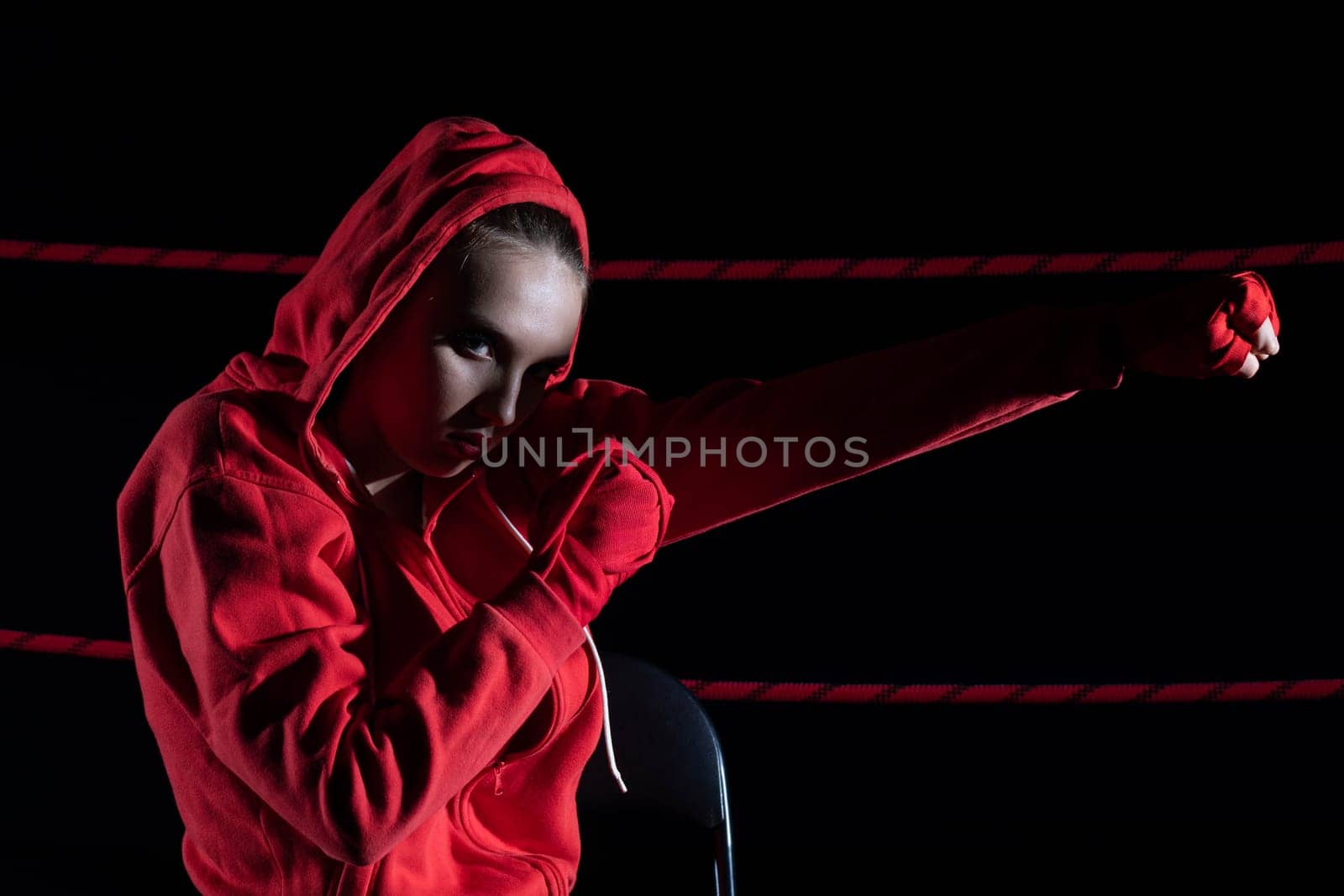 A strong punch with the fist straight ahead to the target. The athlete focused during training just before entering the ring boards.