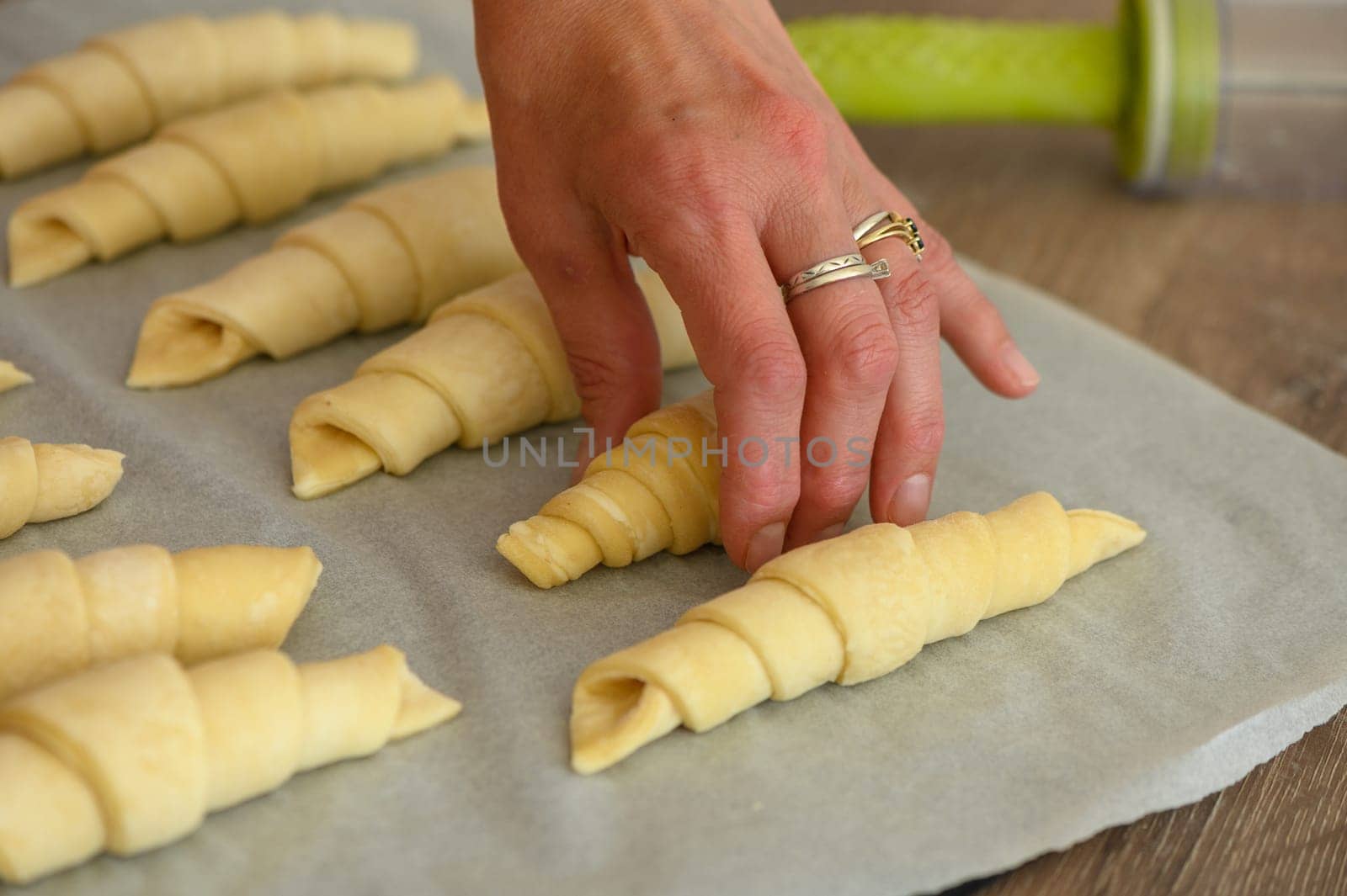 Male Baker Correcting Croissant Shaped Pastries In Modern Bakery 1