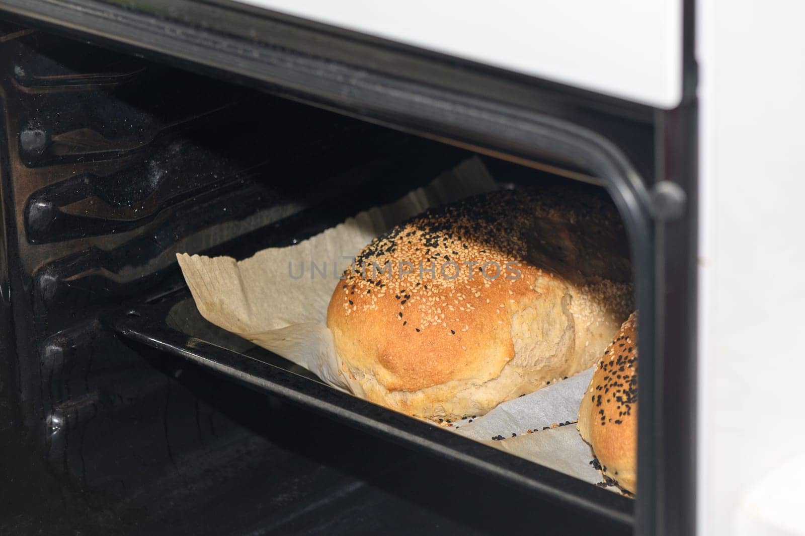 freshly baked bread with black sesame seeds in the oven