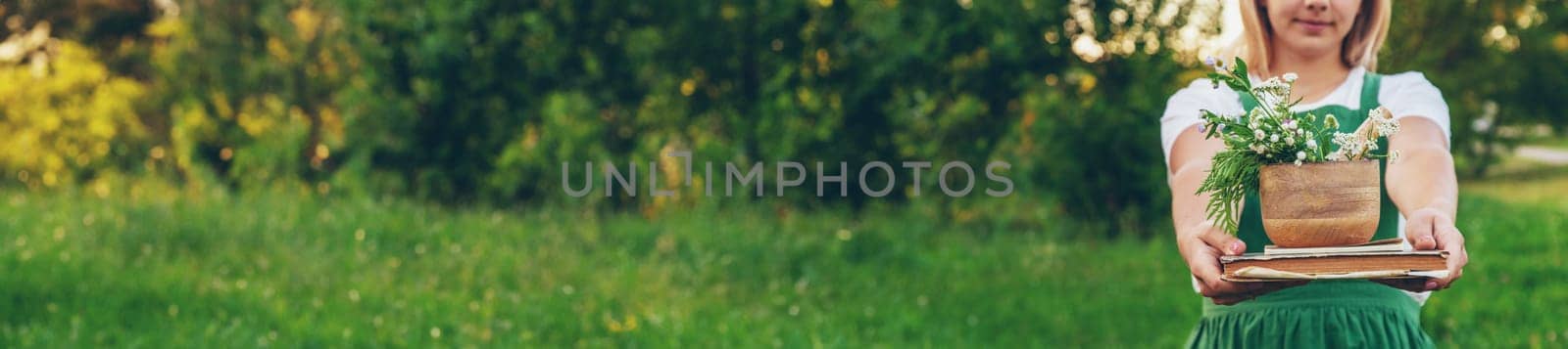 A woman collects medicinal herbs and makes herbal tincture
