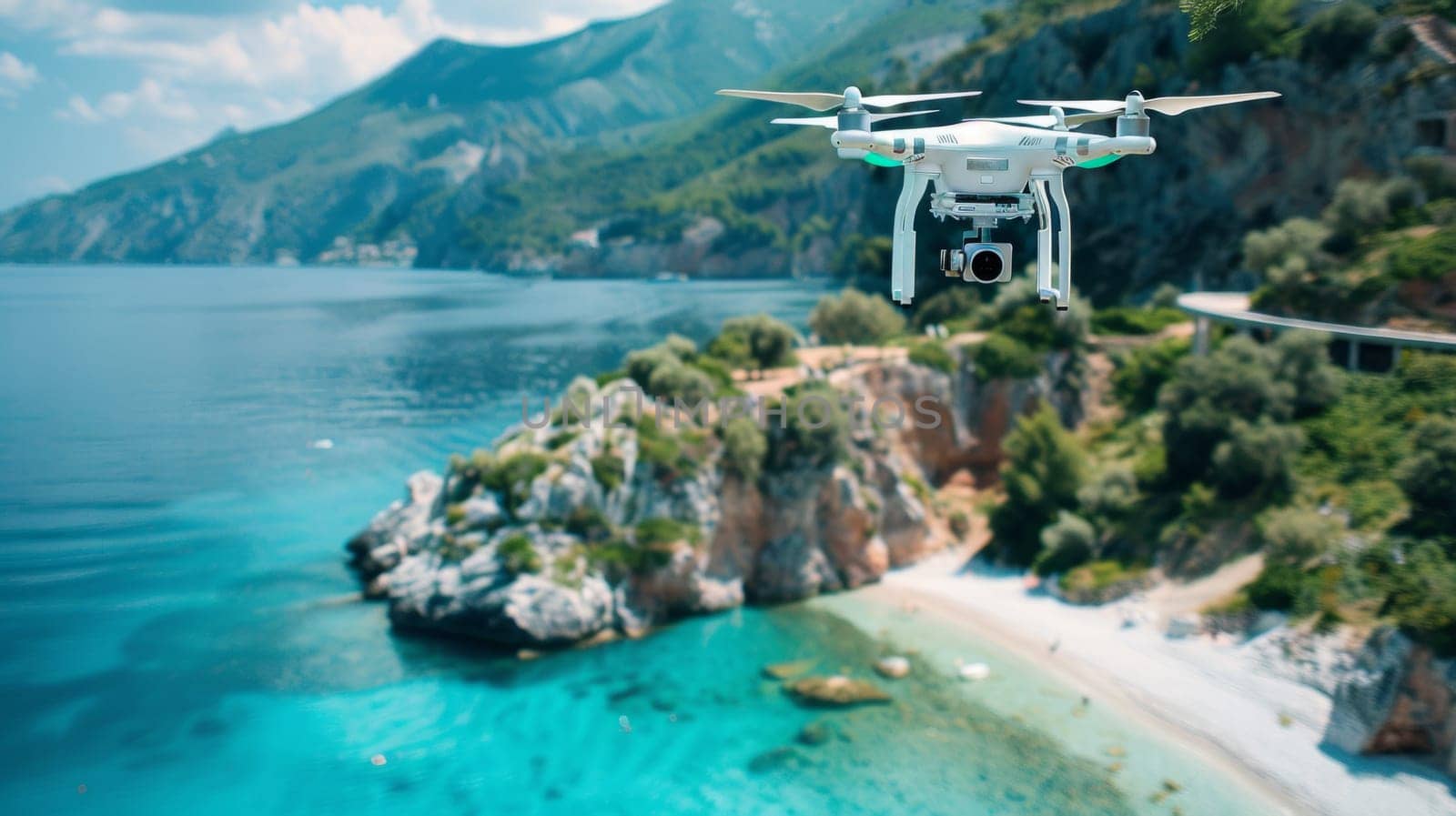 A drone flying over a beach and ocean with mountains in the background