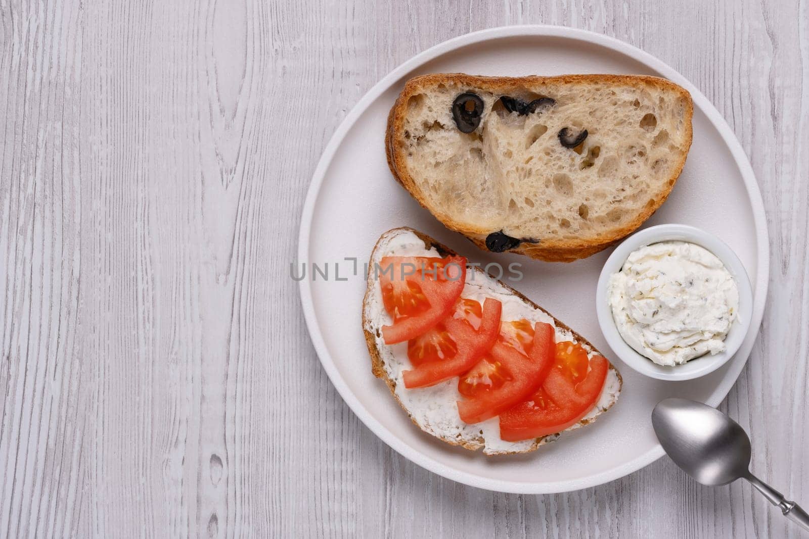 Olive bread with cottage cheese and tomatoes, with copy space for text by NataliPopova