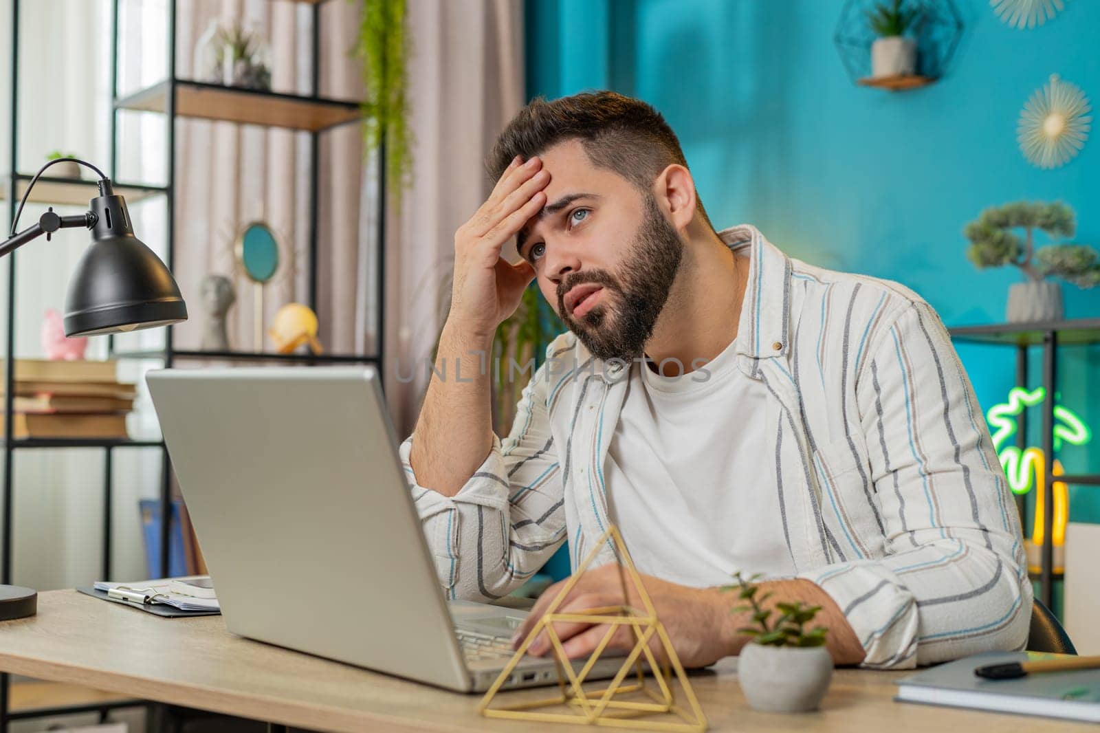 Sad frustrated pensive Caucasian man unrequited love suffers from unfair situation bankruptcy. Problem, break up depressed feeling bad annoyed burnout stress. Guy at home office workplace. Lifestyle
