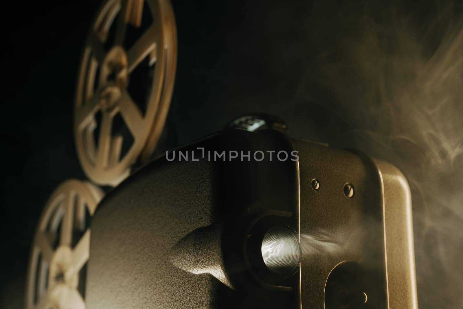 Retro projector playing motion picture in dark room. Timeless flicker of old films. Vintage objects, cinema, Hollywood concept. Perfect for festival background, broadcasting equipment. High quality