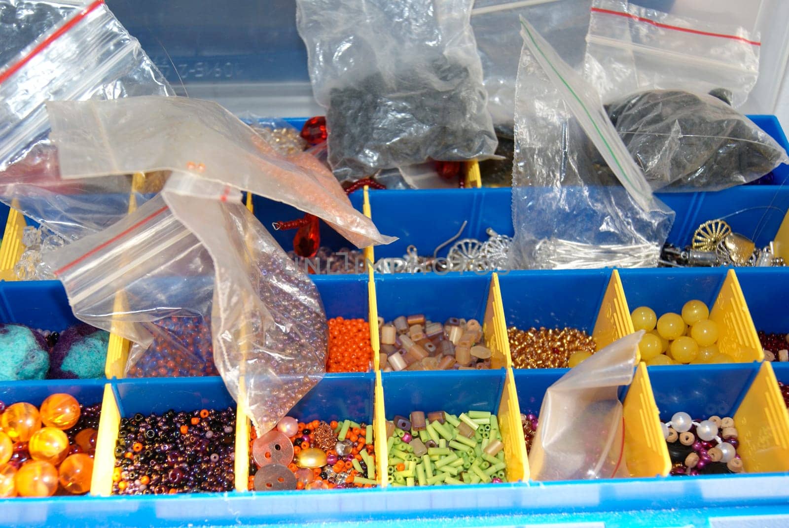 A blue bin overflowing with an assortment of different foods, including fruits, vegetables, canned goods, and packaged items. The variety of foods creates a colorful and diverse display within the bin.
