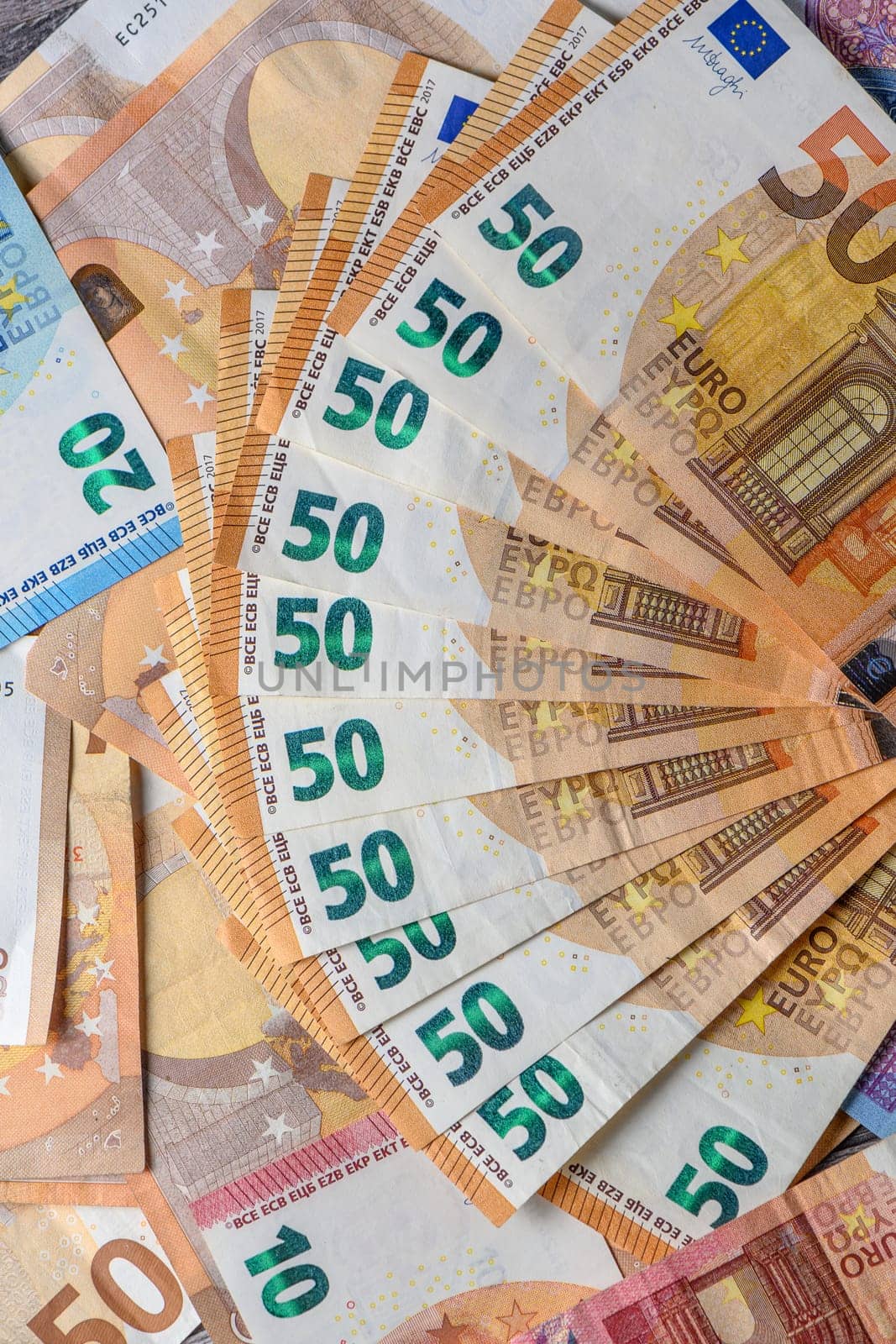 Euro 50 banknotes fanned out on a background of paper bills 3 by Mixa74