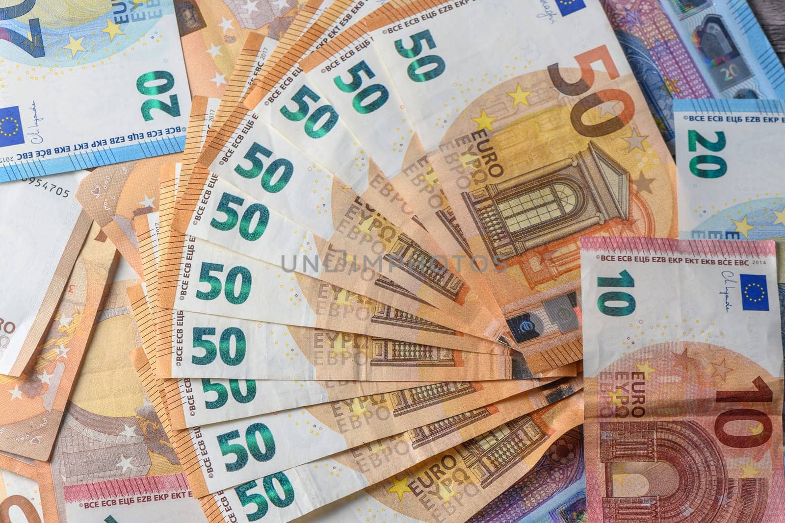 Fifty euro banknotes, arranged in a fan, against money background 6