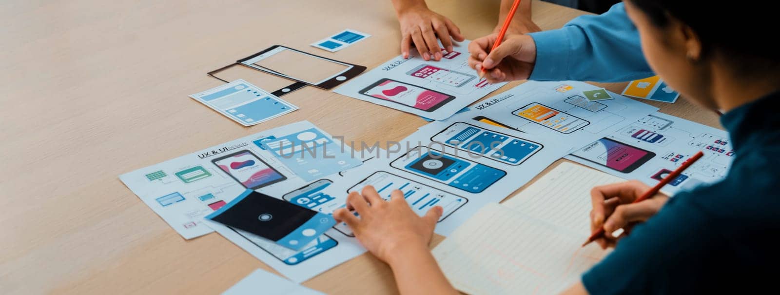Panorama banner of startup company employee planning on user interface prototype for mobile application or website in office. UX UI designer brainstorm user friendly interface plan. Synergic