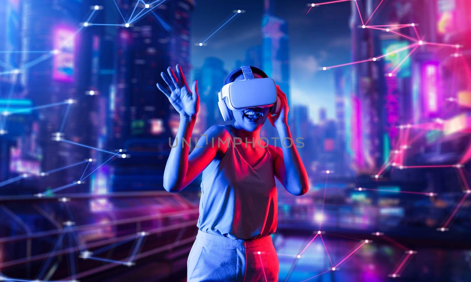 Female standing in virtual reality cyberpunk style building wear VR headset connecting metaverse, future cyberspace community technology, Woman dancing raising one arm holding goggle. Hallucination.