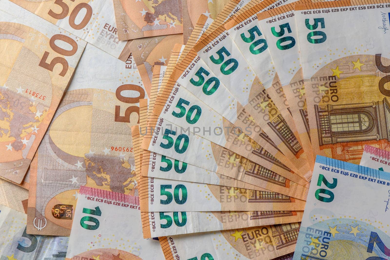 Euro 50 banknotes fanned out on a background of paper bills 6